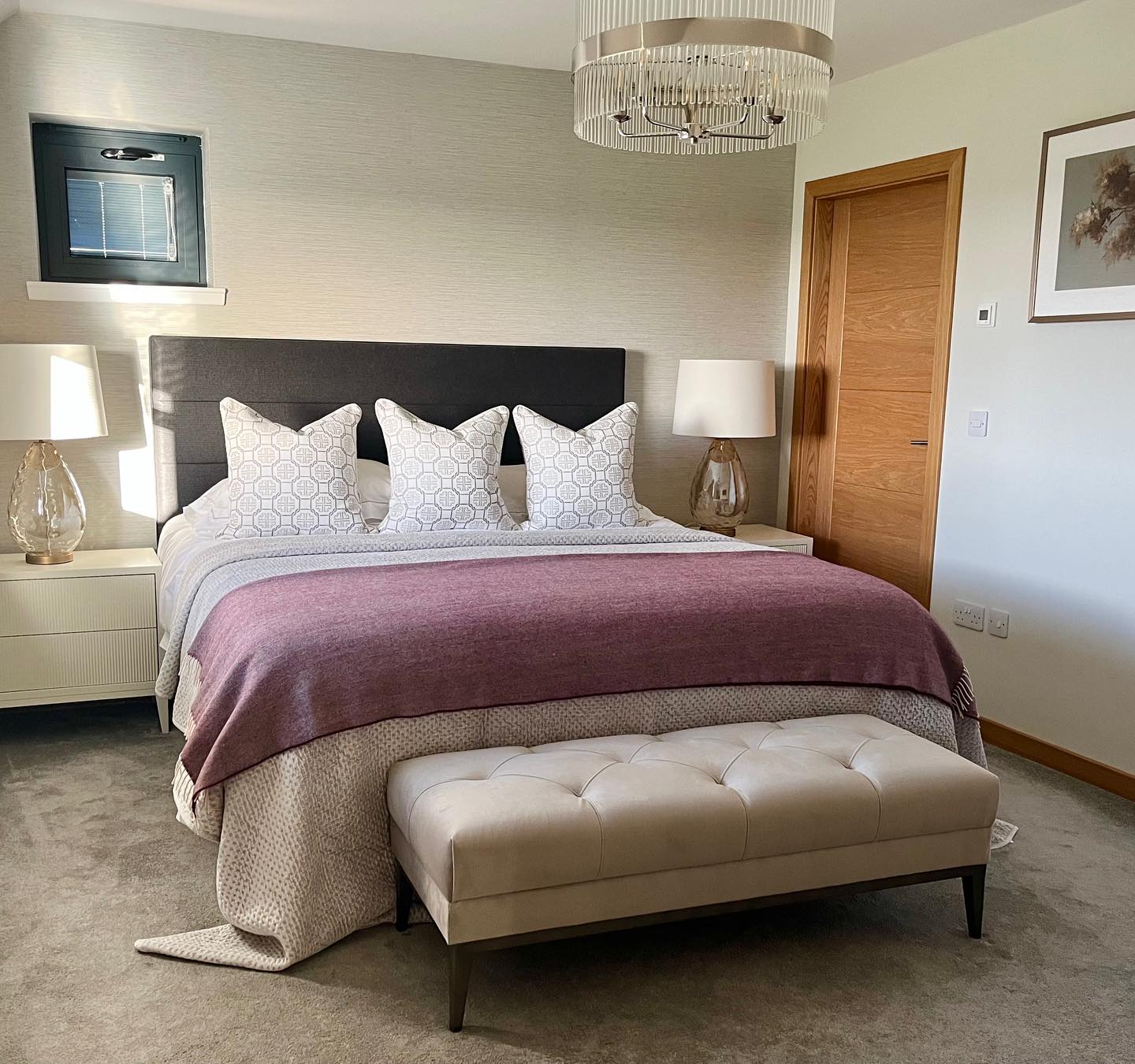 I’ve loved working on this room as it’s quite a departure from my usual classic style and it challenged me to step outside of my comfort zone .
My client really liked the idea of a contemporary boutique hotel style with a calm, neutral scheme and luxurious feel. She wanted to keep her bed but everything else was up for grabs.
We added some beautiful textured wallpaper on the wall behind the bed, wide ribbed bedside tables, statement bedside lamps and ceiling light, velvet bench at the end of the bed, and some beautiful bedding and cushions.
All these elements combined really elevate the room and definitely bring the luxury hotel vibe. I didn’t want to leave!! 😂