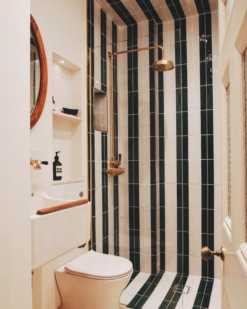 So pleased with how this bathroom turned out in a recent reno. The contrasting colors + floor to ceiling tiles are a combination we didnt know we needed!
