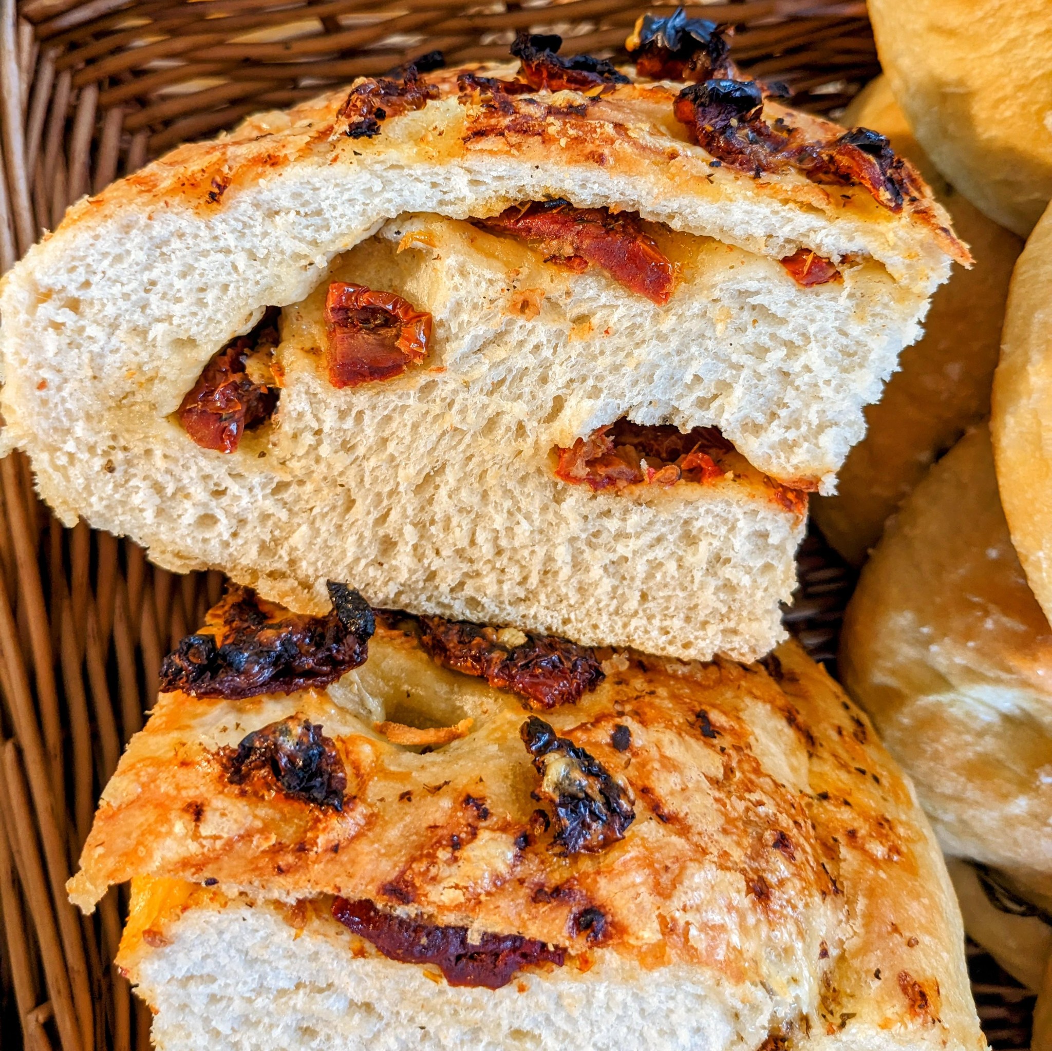 Melissa is getting the hang of folding the sundried tomatoes into the focaccia!
