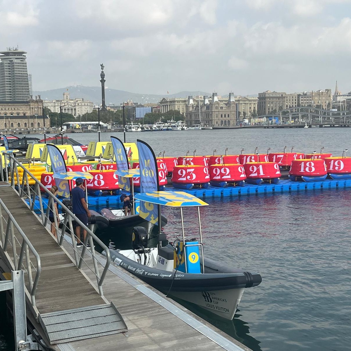 Its been an exciting journey (pardon that phrase), starting four years ago with a huge transition from building coastal cruisers, race yachts and AC chase boats in a large-scale yard, to building custom coach boats in a boutique facility.
Little did we know when we started out, that those coach boats would find their place in so many different ports around the world and specifically now in the playground of this 37th Americas Cup here in Barcelona.
One of the joys of building these boats, has always been working with clients to customize details to suit their specific purpose. In this case, event organisers of the Americas Cup needed an adaptable Marshall boat, easy to transport overseas, easy to handle on the water and able to cope with what can potentially be extreme sea states off the coast of Barcelona.
On-water crowds are expected to grow as the Louis Vuitton Preliminary Regatta gets underway today, so this handy fleet of Salthouse Coach Boats, all the way from little old New Zealand will be busy as ever with boundary mark placement, keeping the crowds off the course and keeping their crew comfy and dry all the while.
It gives us a real sense of pride and gratitude to everyone involved, to see this fleet of 15 boats lined up on the dock, ready for action over the weeks and months ahead.
Happy AC sailing everyone