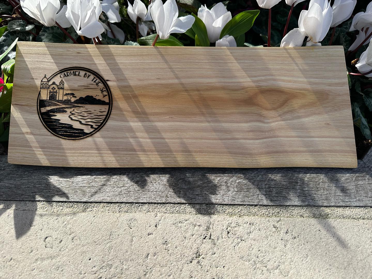 My custom original Carmel By The Sea graphic engraved on a black acacia live edge slab - charcuterie board.