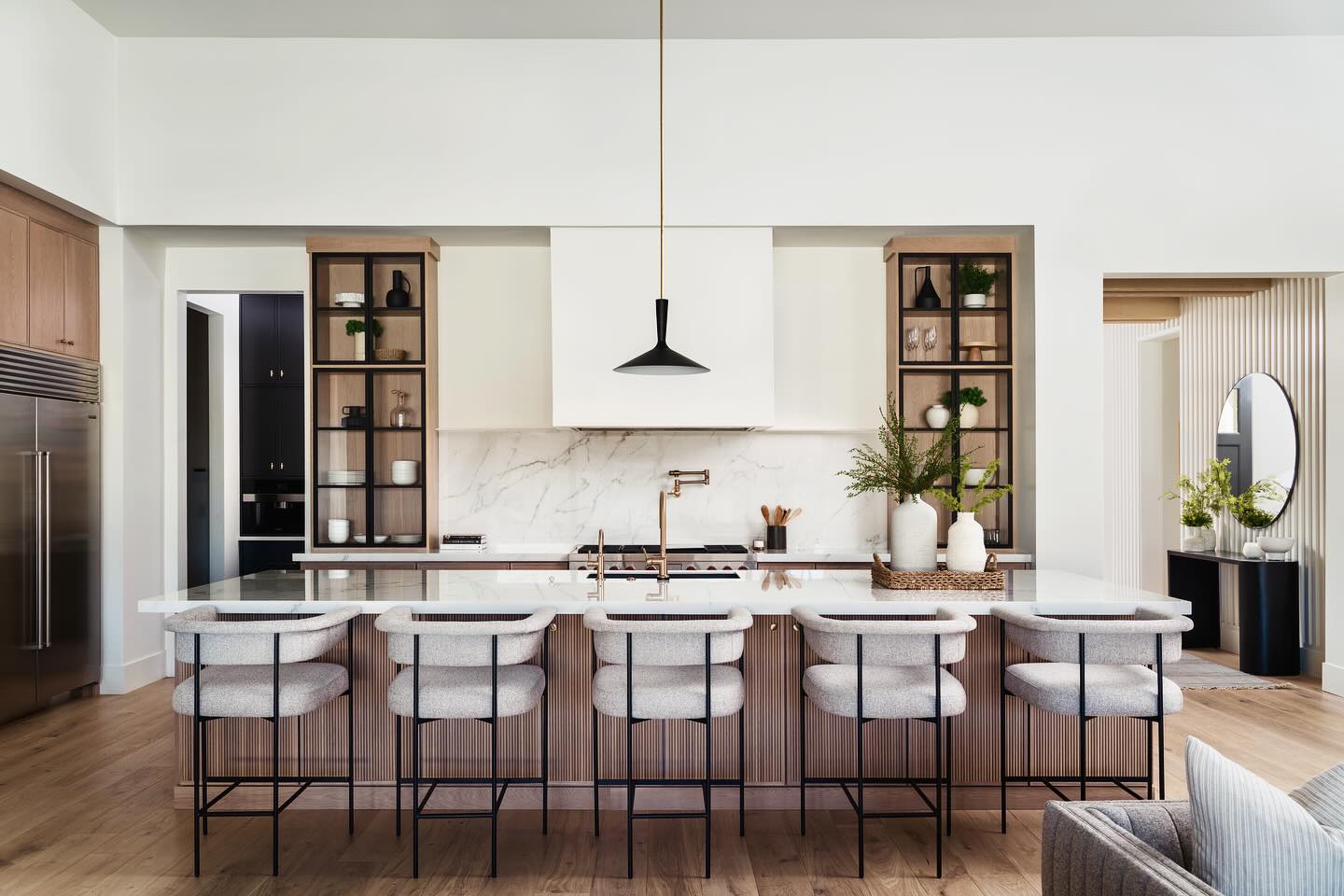 The Jenna Ct kitchen features some of our favorite details including; reeded doors, black metal glass doors and white oak cabinets. Enjoy!