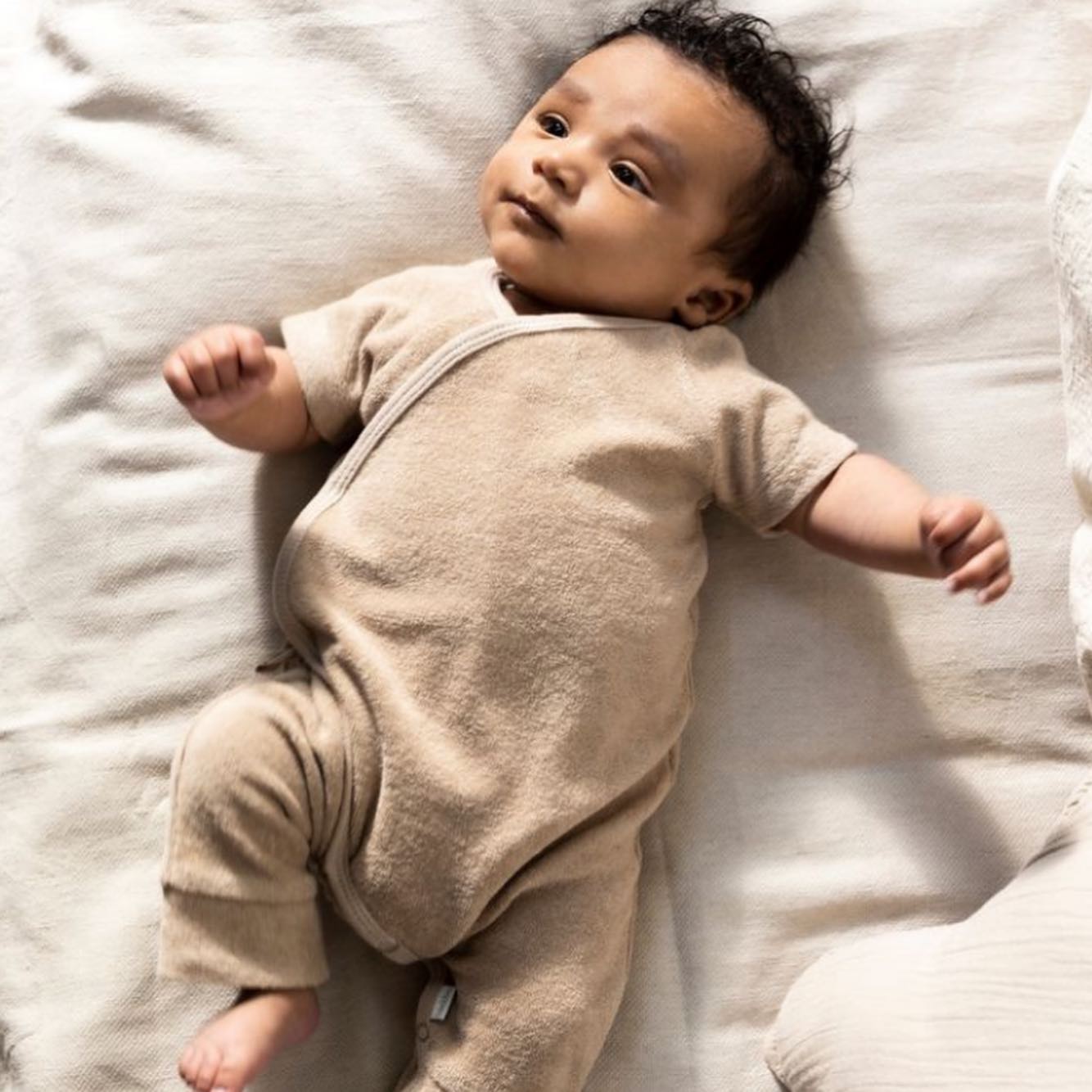 Noppies Organic cotton playsuit. We love this cosy playsuit for newborns - to view Noppies collection of baby items for your store, contact us hello@tcgkids.co.uk #babywear #babybrand #newborn #newbabygift #organic #neutrals
