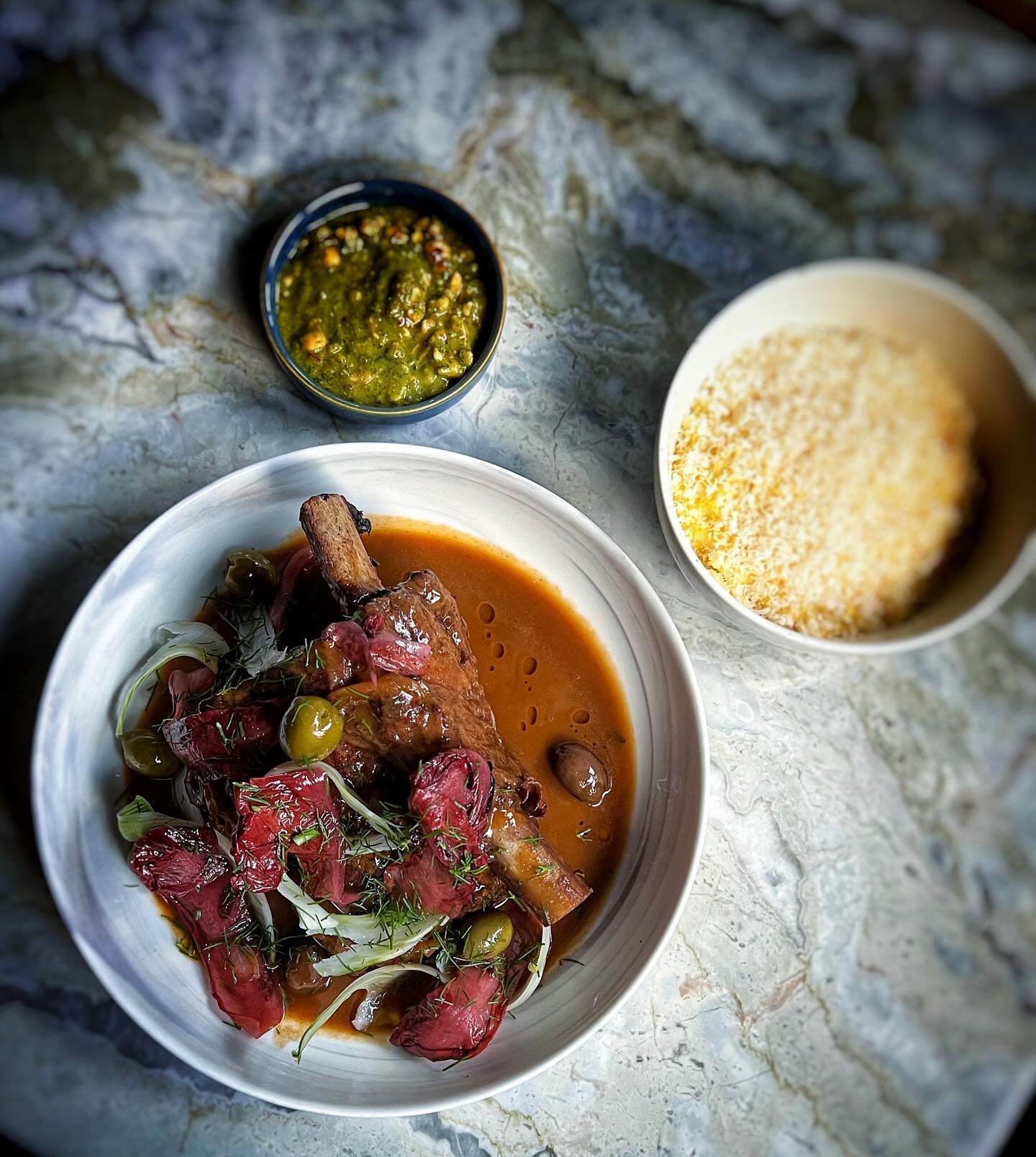 Ruth family farms braised short rib, porcini, fennel olive salad, chicory, parmigiano reggiano polenta, hazelnut salsa verde