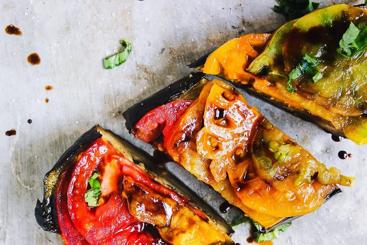 This weeks recipe is: BASIL ROASTED EGGPLANT WITH HEIRLOOM TOMATOES 🍅
Ingredients:
Eggplant Ingredients:
- 2 medium eggplants (see notes)
- 1 teaspoon fine sea salt
- 3 medium heirloom tomatoes, thinly sliced
- 5-10 basil leaves, julienned
- 1 teaspoon balsamic vinegar
- flake salt (optional garnish)
Basil Sauce Ingredients:
- 1/4 cup olive oil
- 1 tablespoon lemon juice
- 1/4 teaspoon fine sea salt
- 1/4 teaspoon black pepper
- 1 packed cup basil leaves
- 1 garlic clove
Instructions:
1. Preheat the oven to 400 degrees and line a sheet pan with parchment paper.
2. Wash and dry the eggplant, cut the ends off and slice lengthwise. Sprinkle the cut side of the eggplant with the salt and rest for 10 minutes.
3. Pat the eggplant dry and remove any remaining visible salt. Place the eggplant cut side down on the baking sheet and roast for 10 minutes.
4. While the eggplant is roasting make the basil sauce. Combine the olive oil, lemon juice, salt, pepper, basil and garlic in a blender and process until completely smooth.
5. Take the eggplant out of the oven and flip over. Brush the basil sauce liberally over cut side of the eggplant and return it to the oven. Roast for 20 minutes or until cooked throughout.
6. Remove it from the oven and rest undisturbed for 5 minutes.
7. Transfer the eggplant to a cutting board and top it with the tomatoes, julienned basil leaves, balsamic vinegar and flake salt if desired.
8. Slice and serve as is, or chill and serve cold.
Notes:
-Medium sized eggplants not exceeding 5 inches in diameter work best.
- Recipe from: https://withfoodandlove.com/basil-roasted-eggplant/#more-9152
#Pactprogram #growtolearn #urbangardening #summercooking #communitycookbook