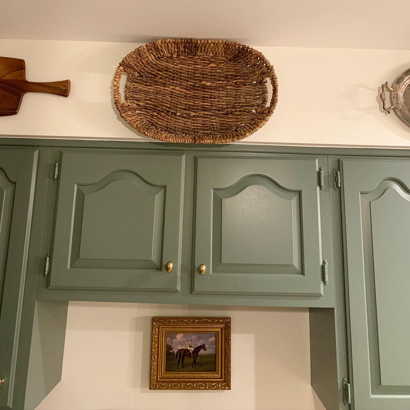🌿Sneak peak at our newly painted kitchen cabinets! We’ve got a few years before we will be able to renovate but we were tired of this space feeling SO outdated.
🌿I wanted a relaxed and natural feel so I went with this beautiful color by Farrow & Ball. Since we aren’t updating the creamy (aka yellow) laminate countertops I also needed the cabinet color to work with those.
Paint Color | Green Smoke by @farrowandball
Design | @hillhousedesignmd