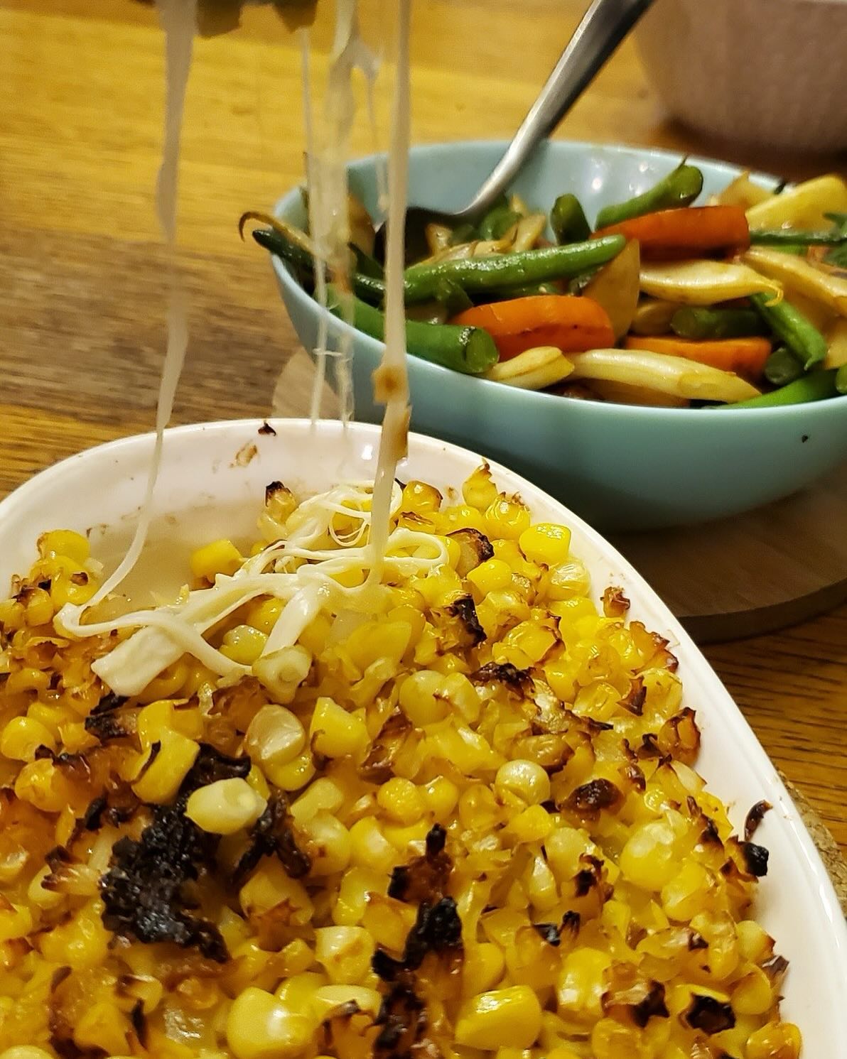 This week we have a 2 for 1 recipe, brought to us by our Fresh Food Box Community member, Lien!
Cheesy Corn Casserole and Sautéed Beans and Carrots
Cheesy corn:
- Kernel from 2 plump ears of *peaches and cream corn (2 cups)
- 1 tbsp ghee or butter
- 1/4 yellow onion, diced
- 1-2 pinches of sea salt
- 2 slices provolone or mozzarella cheese, break in half
- 2 tbsp kewpie mayonnaise or regular mayonnaise
Optional:
- 1 tbsp Mirin
- Garnish with paprika, grated cheese, black pepper
*If using yellow corn or canned corn, add 1/2 tsp cane sugar
Instructions:
- Preheat toaster oven to 400F
- In medium low heat, melt the ghee or butter in a skillet
- Add diced onions and sautéed for 5 minutes until lightly browned and caramelized, stirring occasionally.
- Add in corn kernel and mirin, gently stir until combined and cooked through (5 minutes), should not see any liquid remaining
- Remove from heat and spoon half into a oven safe dish
- Squeeze in a zigzag pattern or spread approximately 2 tbsp kewpie mayonnaise or mayo over corn
- Lay cheese slices until it covers the top completely
- Add in other half of the sautéed corn
- Place in bottom rack of toaster oven or middle rack of regular oven and bake 10 minutes.
- Remove, add the garnish and enjoy!
Flambe beans and carrots:
- 1 carrot, peeled and sliced 1/4 think
- A small bag of mixed beans washed and cut into 1 inch length
- 1 tbsp rendered fat, ghee or EVOO
- 1-2 pinches of cane sugar
- 1/8 tsp sea salt
Optional:
- 1-2 tbsp rum or brandy
Instructions:
- In a skillet used for corn, heat to medium and add in fat, ghee or EVOO
- Once melted, add carrot slices in single layer. Cook each side for 5-6 minutes. Lower heat if needed; do not let it burn
- Add the beans, sugar and salt
- Stir until beans are cooked through (3-7) minutes
- Add the rum and set alight
- Transfer to serving bowl once the alcohol burns completely (15-30 seconds)
Enjoy!