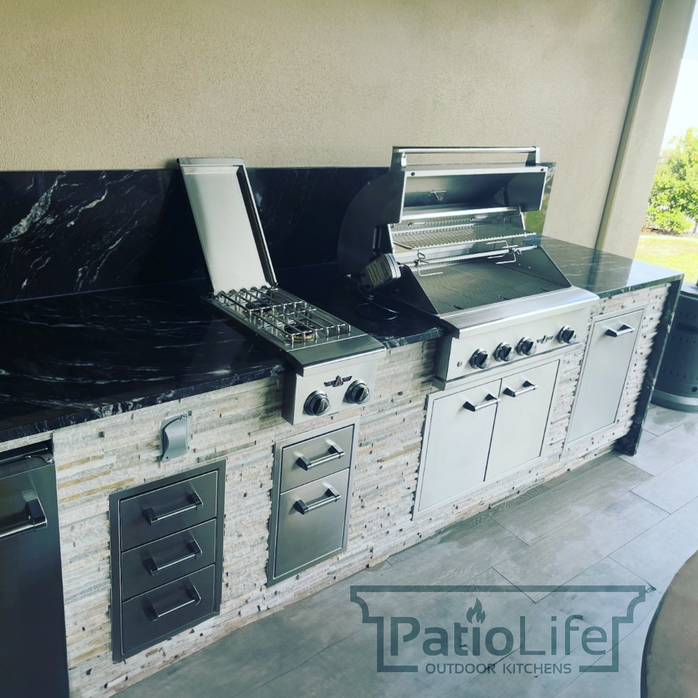 A beautiful custom PatioLife outdoor kitchen with Delta Heat appliances & storage.