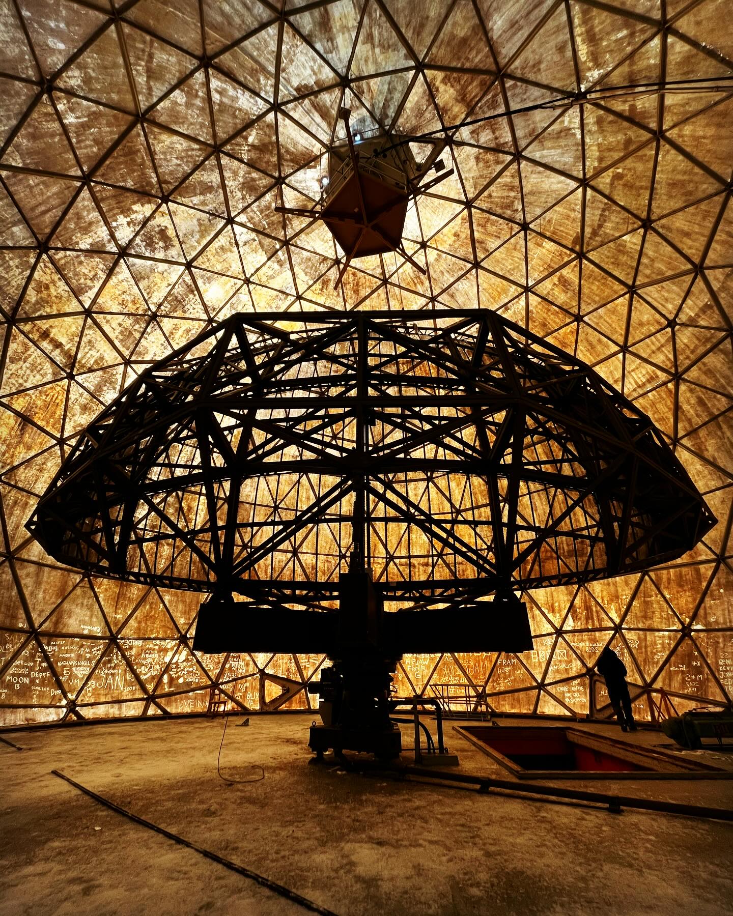 DYA 2 📡
During week two we came across DYA 2, an abandoned American Cold War early warning radar station. Only the radar and the top story of this huge 5 story structure peek out of the ice cap after years of storms battering and burying it. Within 20 years or so, DYA 2 will vanish forever with Greenland engulfing the entire station with snow and ice. 😲
We decided to camp next to the station whilst trying to organise an evacuation for our teammate and while waiting, we clambered across the old roof managing to find a way into the station just below the radar structure. No health and safety here, just head torch time 🔦
Imagine if all the scary shit in The Blair Witch Project took place in a top secret, 1980s military base and you’ll have a good idea of what it was like venturing inside what was an absolutely massive, icy time capsule. It was properly spooky inside becoming colder, darker and more dangerous as we explored deeper and deeper until ice and major structural damage stopped us from exploring the final 5th floor which is now buried deep under the Greenland Ice Cap. We had to tread carefully.
It was such a weird but exhilarating experience because apart from the ice and snow slowly invading every inch of the station it appeared as if everyone who’d been working there had only just left. 😯 It was also a welcome change of pace after skiing solidly for two weeks.
With a staff of around 60, the station was completely self sufficient back in the 1960s-1980s, keeping track of any potential Russian nuclear missiles being launched across the Arctic Ocean. A state of the art facility with massive pneumatic struts that could lift the entire station during major storms, DYA 2 along with many other similar stations would be able to give the US government about two hours notice of any missile strike and all-out nuclear war. Yey…😵💫
Finding something like this in the middle of nowhere after two weeks of seeing nothing and no one was pretty mind blowing and one of the highlights of a pretty insane expedition. 🤯
#dya2 #greenland #greenlandcrossing #exped #adv #coldwar #spooky #explore #fsgs #kidneytransplantrecipient