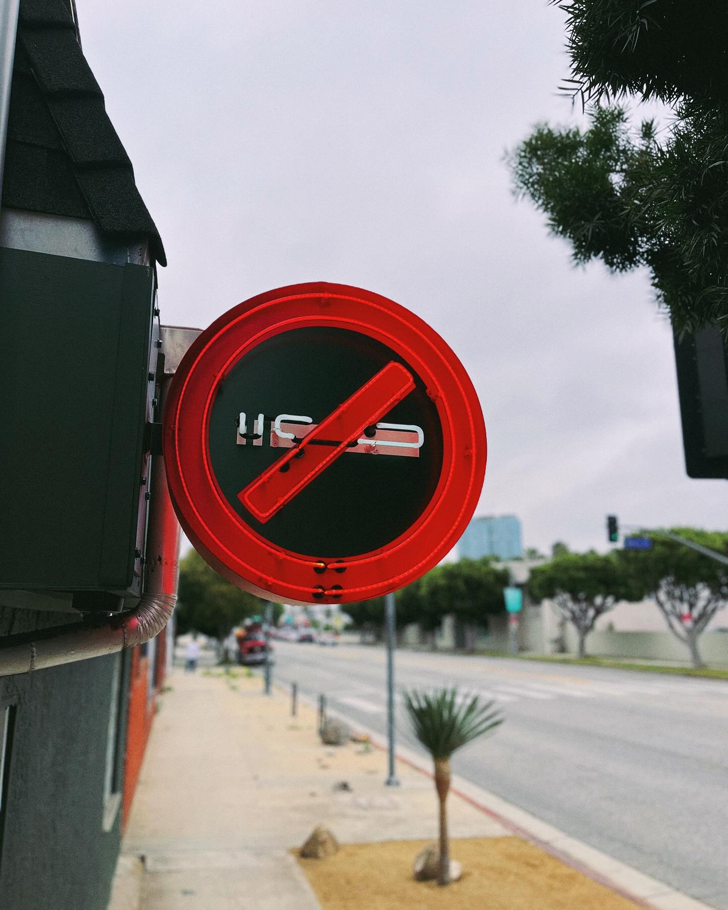 This is a custom sign!
This type of sign is known as a “Blade Sign” designed to be mostly viewed by pedestrians walking on either way along the sidewalk from a distance as opposed to a front sign which is normally only visible from a straightforward angle.
Pictured: A fabricated aluminum circle with painted finish and white and red neon units mounted on top.
It includes a custom size mounting metal plate painted black. The neon GTO-Wiring is housed through the inside of the sign while the power supplies (neon transformers) are inside the building connected to a dedicated electrical line.
#customsignage #neonsigns #bladesign #paintedsign