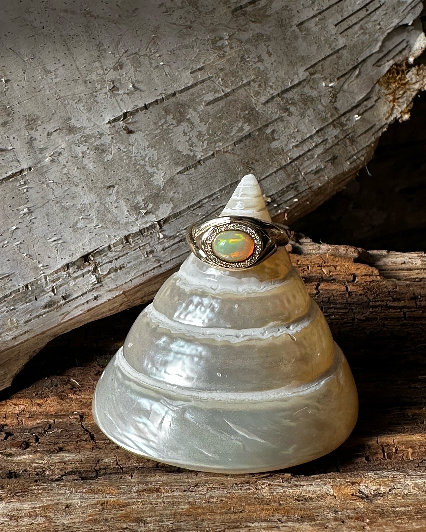 Opal. One of my favorite stones to get to work with. ✨ Sometimes people describe it as iridescent but in actuality it has its this specific quality of a hazy sheen of milky light in all the colors from within the stone. Gemologists call it opalescence. ✨
Many cultures have credited opal with supernatural origins and powers. Arabic legends say it falls from the heavens in flashes of lightning. The ancient Greeks believed opals gave their owners the gift of prophecy and guarded them from disease. Europeans have long considered the gem a symbol of hope, purity, and truth.
It’s the birthstone for October and I think it’s most beautiful sunk into gold. This ring was so much fun to make - a hand carved wrapped sculpture of a ring framing the opal and set with pavé set diamonds for a different sparkle of light.
Three beautiful sisters were involved in making this special piece to mark a moment in time that I hope she wears forever ❤️ @phoebequinkong #customisbest#opal#love#katherinelincoln#madeinnyc#nyc