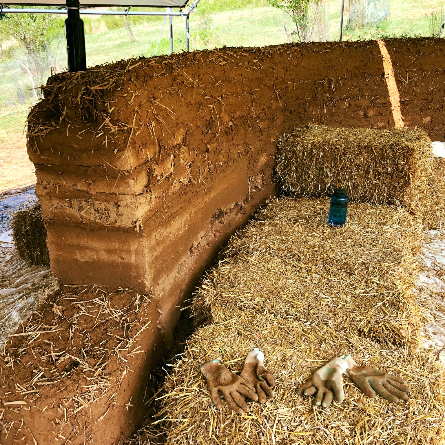 Let's dive into clay walls today!
Clay is found in soils around the world. It's magical quality stickiness when you wet it...allowing you to mold & form. Then when it dries, it gets quite strong.
What does this mean for building?
It means you can dig soil out of the ground, add water, and form it into bricks, sculpted walls, floors, plasters...sky's the limit! The result is strong & made from free materials.
Nitty-gritty details
Clay soil usually comes out of the ground mixed with rocks & sand. The sand is essential, because it strengthens the clay & helps minimize cracking as the clay dries. Often fiber (such as straw) is added to knit your material together & further reduce cracking. There are many other ingredients you can play around with.
Common types of clay walls include:
rammed earth (sand & clay tamped into forms, like making your own stone)
adobe (wet clay, sand, and fiber poured into forms & dried in the sun)
cob (same as adobe but formed in place)
wattle & daub (woven walls of bamboo or twigs with a wet plaster-like mixture of clay and long fiber)
All of the clay walls are in the category of "thermal mass" materials. This means they conduct heat energy and store the heat like a battery. When the clay wall is warmer than it's surroundings, it releases the stored heat. When cooler than the surroundings, the clay pulls ambient heat out of the air. This means clay walls are great at cooling spaces in hot climates (if the clay is completely in the shade). And clay can be used with passive solar design or with mass wood heaters to absorb excess heat and store it for later comfort.
What clay walls are not: is insulating! Insulators block the flow of heat. Clay does not do that! If you need walls that insulate, strawbale or hempcrete or wool etc. are what you need (then keep your clay walls inside the insulated space).
Photos show:
wall with rammed earth, adobe bricks & cob
making adobe bricks
forming cob walls
clay plaster over cob walls
#cob #rammedearth #adobebricks #claywalls #buildwithwhatyouhave #clayplaster #thermalmass #naturalbuilding #buildnaturally #sculptyourspace #naturalbuildingterms