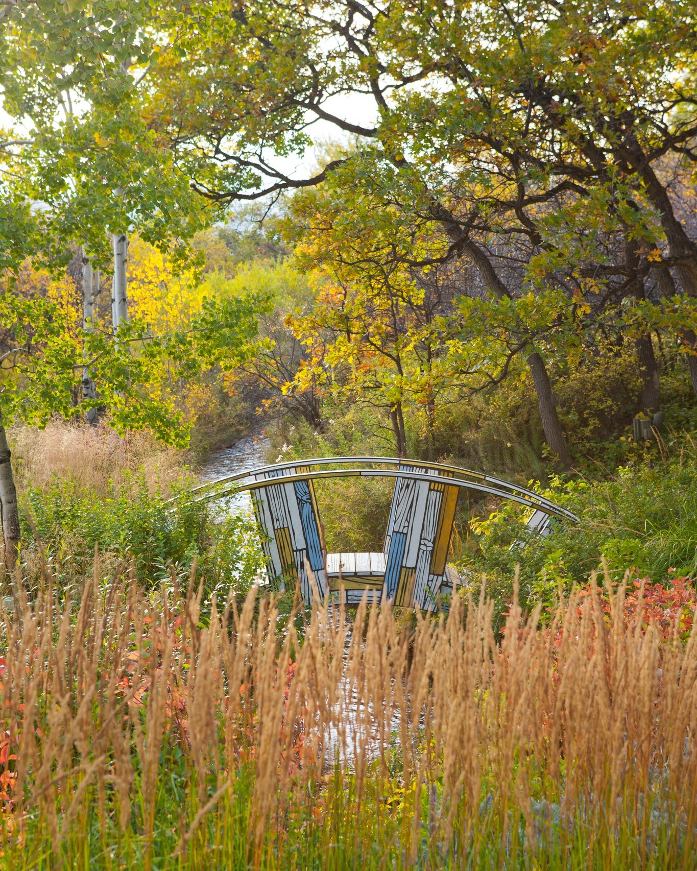 a custom made beauty with a pop of color, bringing functionality and art to this backyard oasis. ✨🍂
Tucked within #native shrubs and an overstory of aspen, spruce and gamble oak trees, this journey from bank to bank provides expansive views of the stream course below to the mountain vistas beyond. 🗻 Take a moment to observe the individual roles of the vegetation and wildlife, working together in harmony to create a #functionalecosystem.
📸: @jasondewey
#landscapearchitecture #landscapearchitect #landscapedesign #design #gardendesign #nativeplantings #sculpture #bridge #garden #designinspo #artinstallation #luxurygarden #colorado