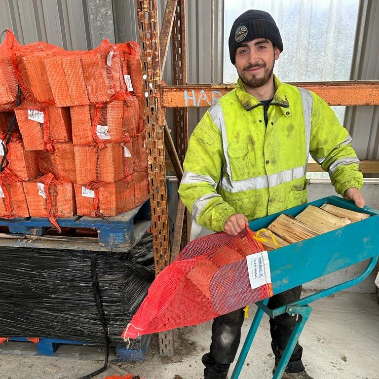 Joe is happily prepping nets and packing bags of logs ready for delivery, under the strict supervision of Thor the log dog!
