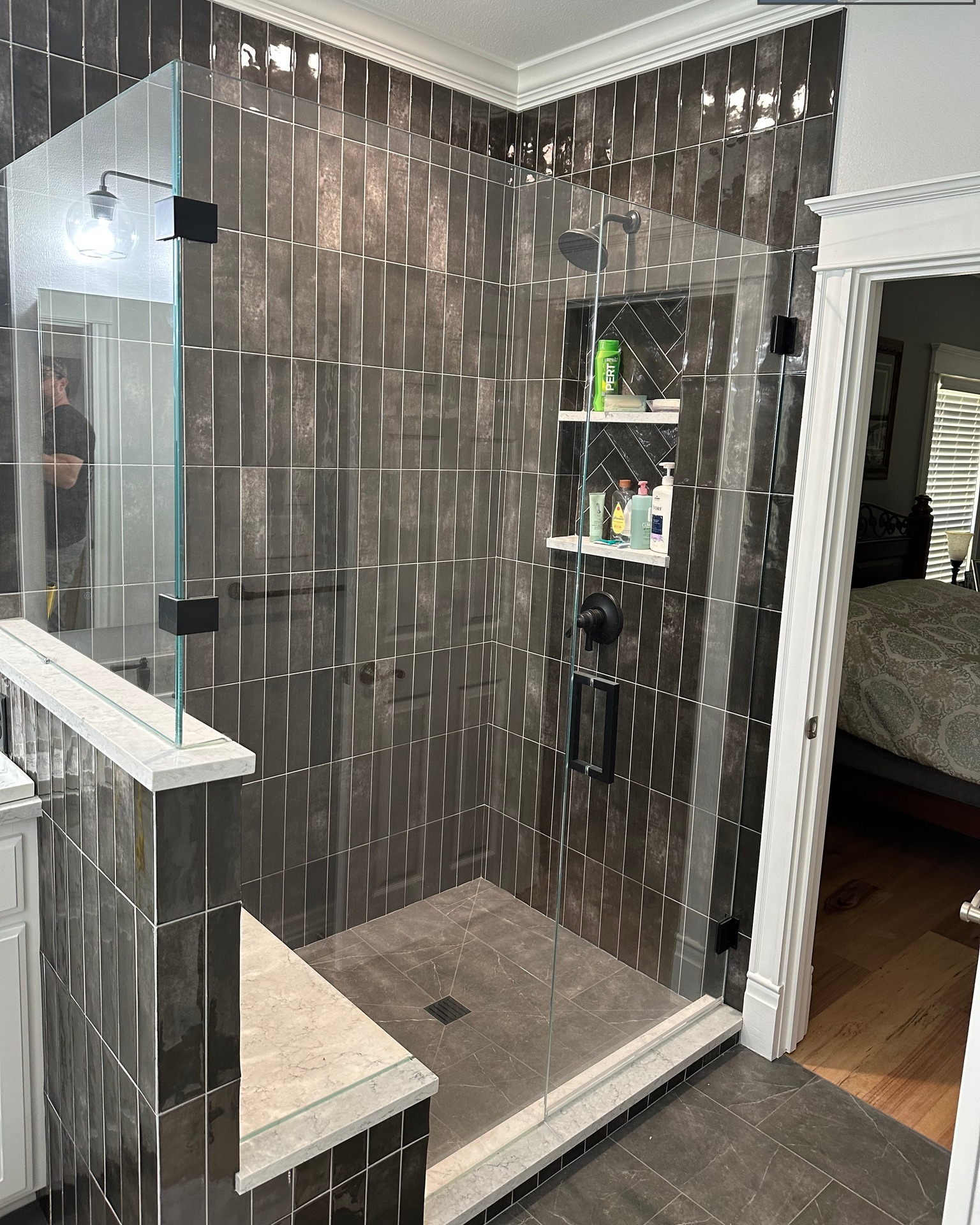 Finished pictures from the Nottingham Project. The change in these bathrooms was very much welcomed by the homeowners! Removal of the shower insert partition wall creates a more spacious feeling master bathroom, however we did increase the primary shower size by quite a bit. I love it when a homeowner lets me have design input, and I think the dark vertical subway and the dark floor turned out great! We changed it up a bit for the guest bathrooms, but the contrasting tile pattern helped keep the clean white look from becoming too disinteresting. Stay tuned for some other finished pictures.
#abovestandardsllc #remodeling #bathroomremodeling #bathrooms #tileshower #laticrete #tilegeek #centralarkansas #conwayarkansas