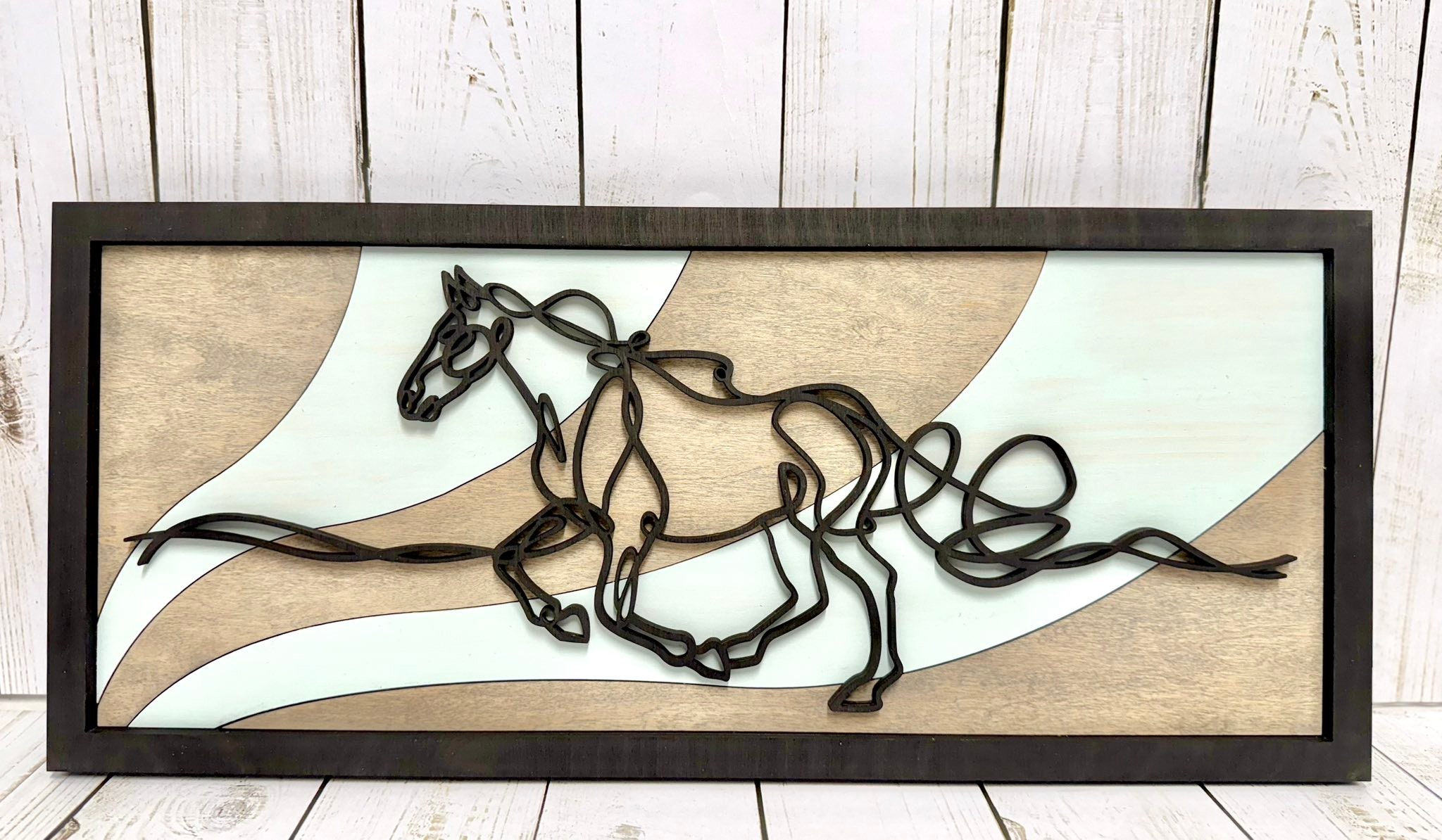 Beautiful line art wooden artwork. Many more designs to choose from, just ask for a sample Can also be customized with a saying or name. Measures 18” x 8”