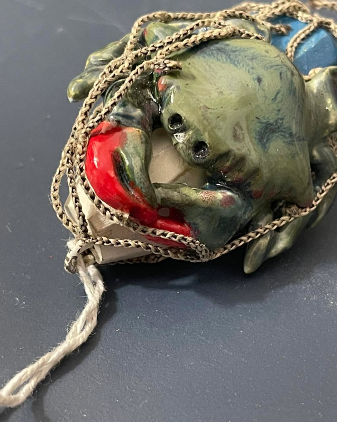I have three ceramic crab ornaments available! This is just one. The buoy is wood and the crab is covered in retired fishing net.