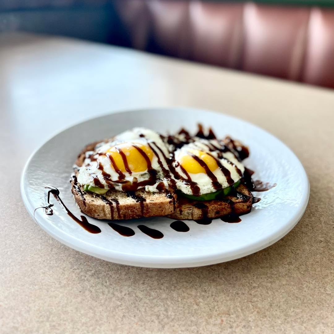 Try our popular Avocado Toast today! Multigrain toast topped with sliced avocados, sunny-side eggs & drizzled with a balsamic glaze. Served with your choice of homefries, hash browns or seasonal fresh fruit. 😋🥑🍳
