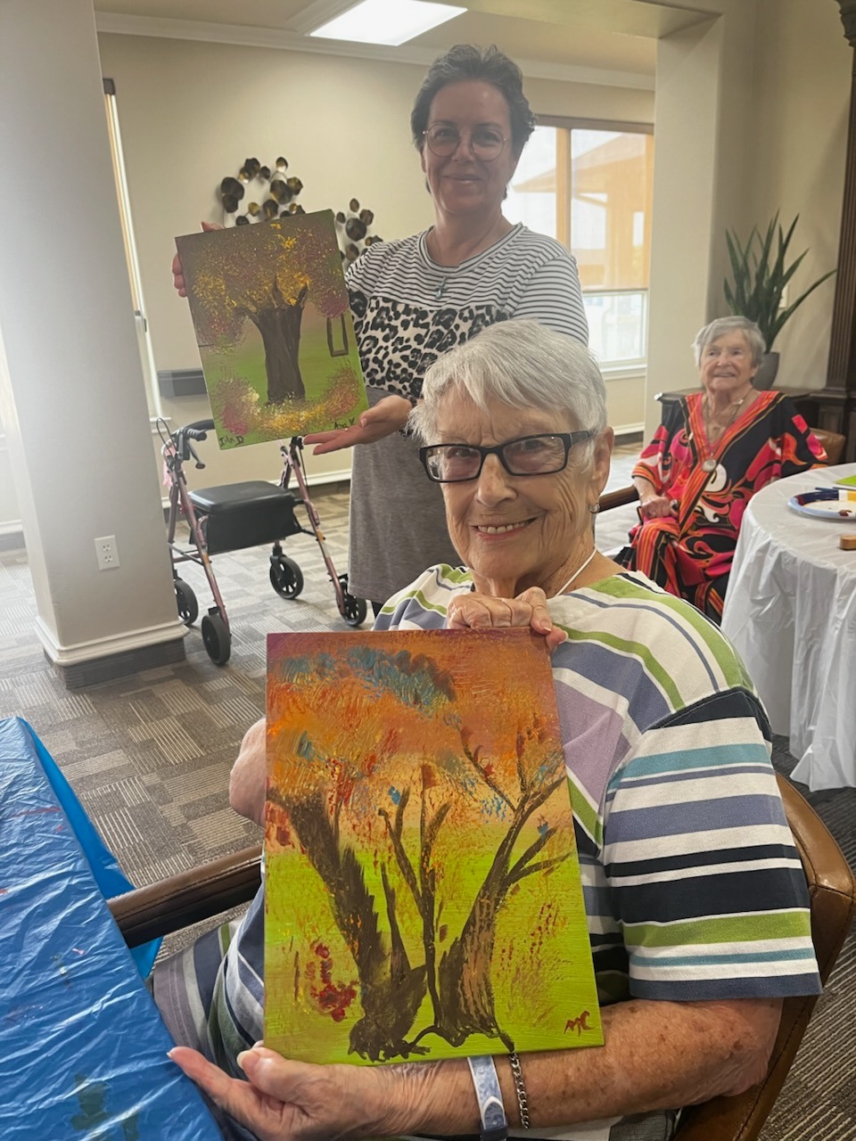 This past week, a few of our talented membered artists brought creativity and joy to the residents of Arbor House, a senior living facility in Marble Falls, TX!
Led by the talented Therese Coniglio, with the help of Marci Rice and Nikki Phiroz, residents enjoyed a fun and engaging acrylic painting lesson. It was a heartwarming day filled with smiles, stories, and artistic expression!