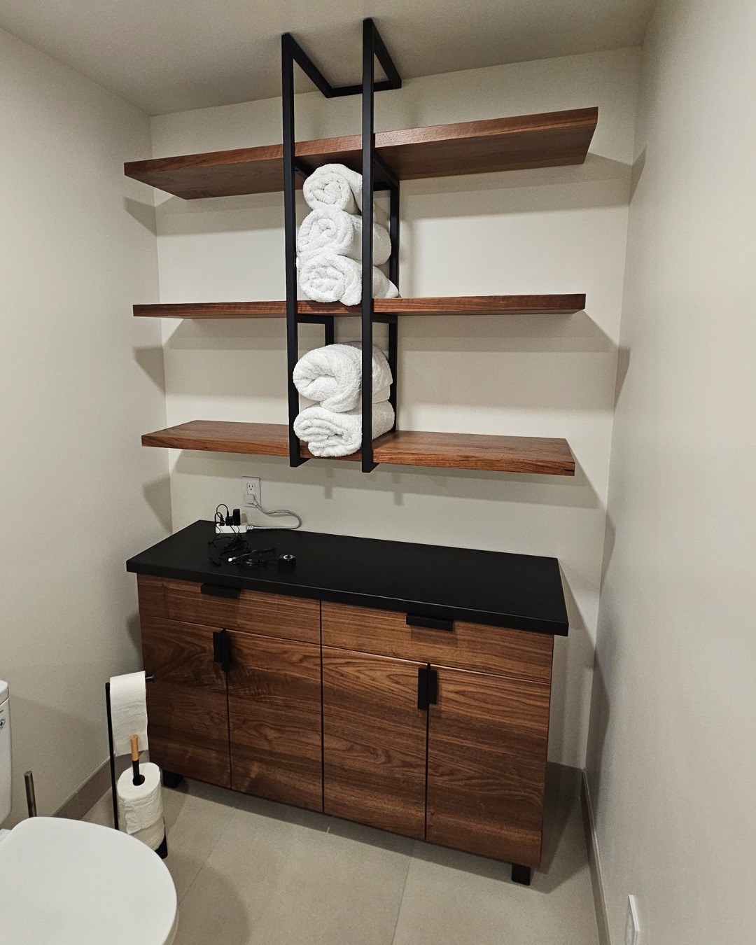 Designed to complement the new walnut vanity (see the previous post), this storage cabinet and shelving tie together the black steel and solid walnut pieces throughout the house. With a steel top, continuous grain doors, towel holders and custom pulls, we designed an ideal solution for our client's bathroom remodel.
#customfurniture #bathroomdesign #remodel #furnituredesign #furnituredesigndenver #interiordesign #mountainhome