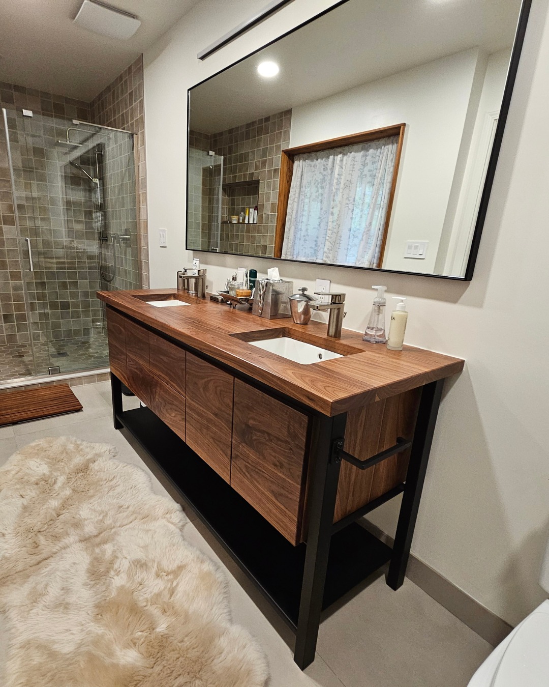 We have made several pieces for this client over the years and greatly appreciate having the creative license we were given for each project.
This solid walnut and steel vanity carries a bit of design in from the custom desks we made a few years ago. The door faces feature continuous grain and a steel shelf adds storage.
A steel framed mirror, towel racks and wall cabinet tie it all together.
#customfurniture #furnituredesigndenver #vanity #interiordesign #doublesinkvanity #custommetalfabrication #custommetalwork #customsteeldenver
