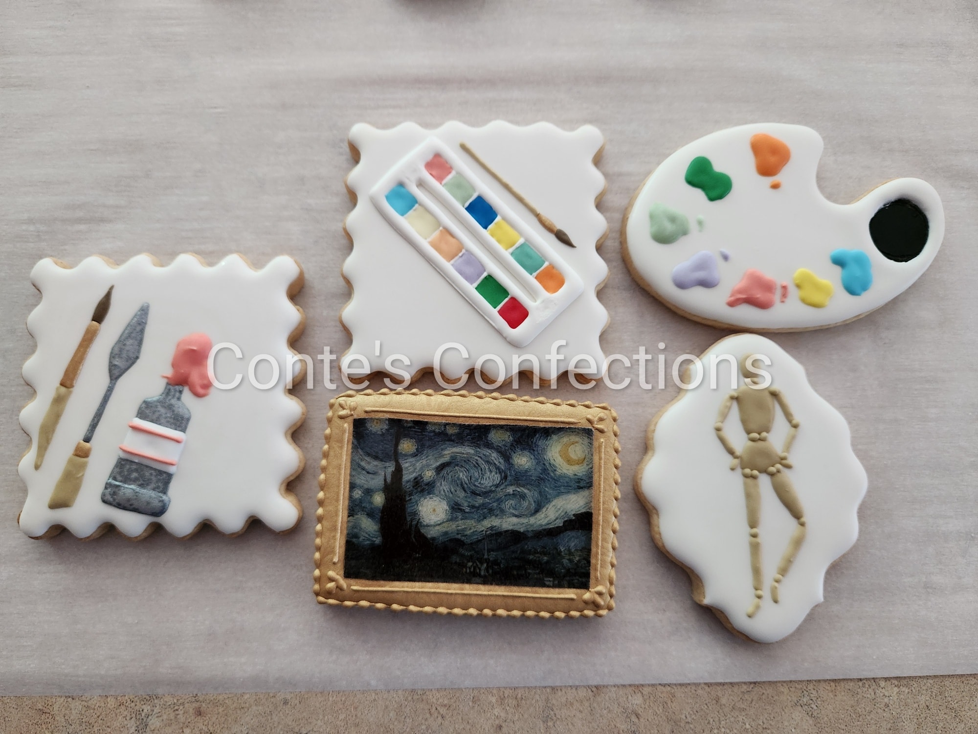 Art themed sugar cookies. The painting was printed but the gold frame was hand piped.