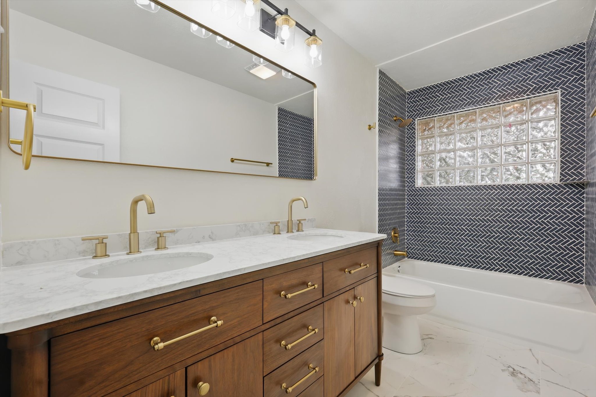 Clean lines, warm wood, and a bold herringbone tile make this bathroom stand out. At Oikos, we bring together timeless finishes and modern details to create spaces you’ll love every day.
#OikosRemodel #Dallasremodel #BathroomDesign