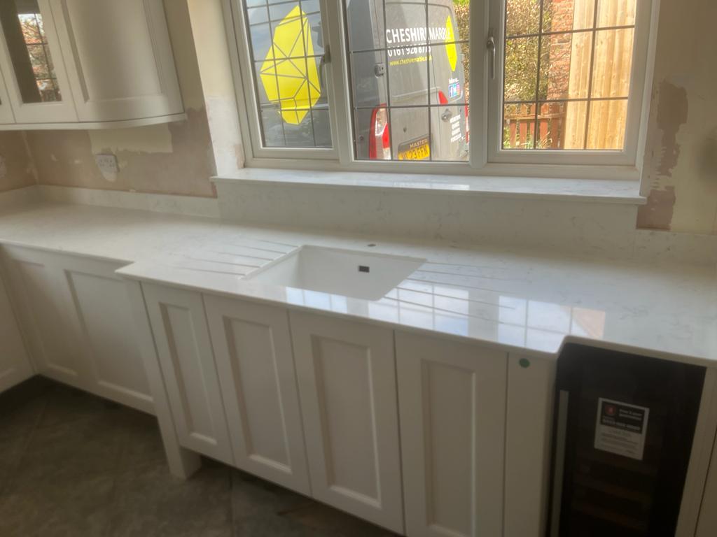 Carrara quartz tops with breakfront details and window sills #kitchenworktops #worktopscheshire #kitchendesign #homeimprovement #quartzworktops
