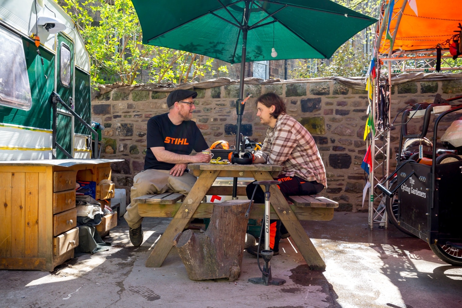 Gardeners probably discussing plants and such like, in our yard at the end of a long day.