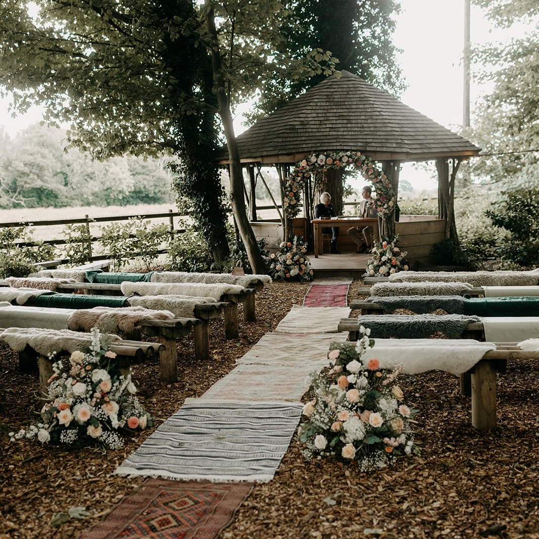 🌿✨ Woodland “I Do’s” ✨🌿
This outdoor ceremony setup captures everything we love about Crown Lodge — natural beauty, cosy textures, and timeless romance. 🌸
From layered rugs creating a charming woodland aisle to the floral arrangements framing the gazebo, every detail invites warmth, comfort, and connection. 💕
Would you choose an outdoor ceremony like this? 🌿
📍 Crown Lodge, Kent
💍 Exclusive-use wedding venue
📷 @peter_reynolds_photography
#crownlodgekent #KentWeddingVenue #WoodlandWedding #OutdoorCeremony #RusticRomance #WyeDowns #WeddingInspo #NatureLovers #UKWeddings #BohoWeddingStyle #inclusivewedding #weddingphotography
