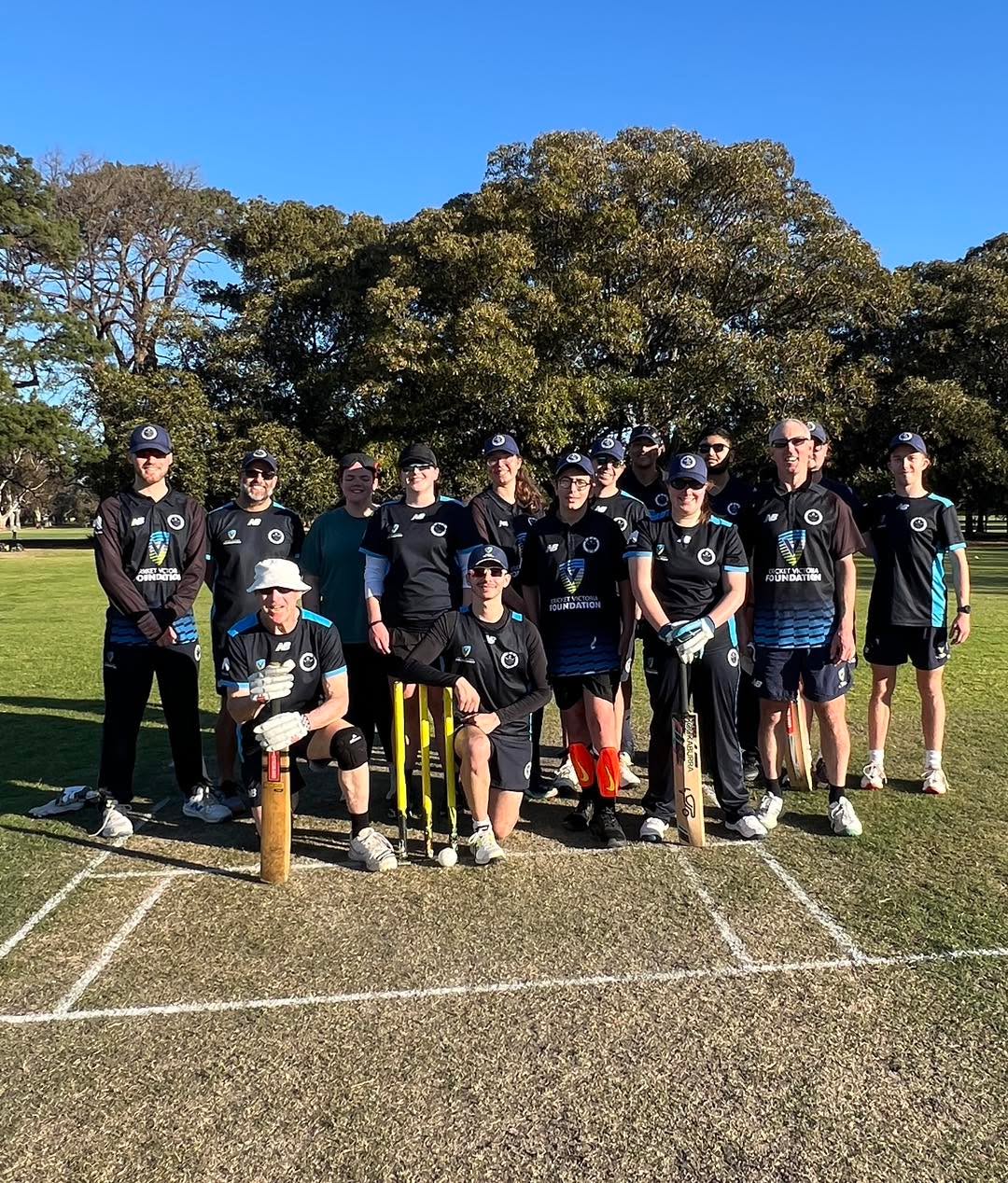 Great to see so many players for our first centre wicket training session yesterday.
Perfect opportunity to develop skills, team connection and bash a few balls around beautiful Fawkner Park.
#blindcricket #inclusivesport
Image description: group of 15 men and women blind cricket players in VBCA uniform gathered around a set of stumps, facing the camera. Cricket pitch in the foreground. Trees and park in the background.
