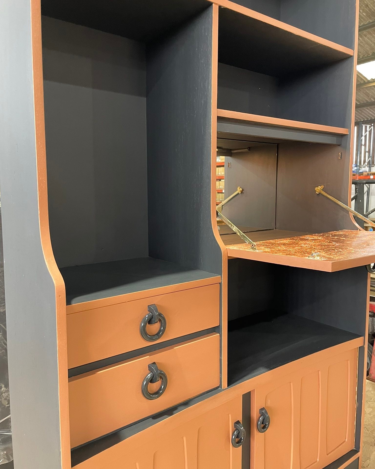 ✨ Just finished! ✨
This gorgeous wall unit has had a complete relove — a real statement piece with plenty of character.
It’s a mix of open shelves, 2 drawers, and cupboards to the bottom — plus a fold-down bar for a little extra magic 🍸
I’ve added faux silver leaf and rose gold leaf to the inside of the bar door for a touch of glamour, along with a mirror and a rechargeable sensor light. There’s another light option - I can add to the top shelf if you fancy, for a small extra charge.
The unit has been painted in a deep grey and warm clay acrylic, the knobs have also been painted in grey and then glossed. The lovely curved cupboard top adds style, but is tricky to capture in photos!
I can just see it in a quirky home — styled with books, plants, and gold photo frames.
A perfect piece to make your home feel cosy and special for winter
Details will be up on my website soon, but message me if you’re interested in the meantime.
#RelovedByJo #VintageFurniture #60sFurniture #70sFurniture #FurnitureRestyle #UpcycledFurniture #StatementPiece #MidCenturyStyle #CharacterFurniture #HandPaintedFurniture #InteriorInspo #CirencesterLife #HomeDecorInspo #CosyHomeVibes #FurnitureWithSoul #RusticCharm #FurnitureTransformation #HomeStyleInspo #VintageHomeDecor #RetroRevival