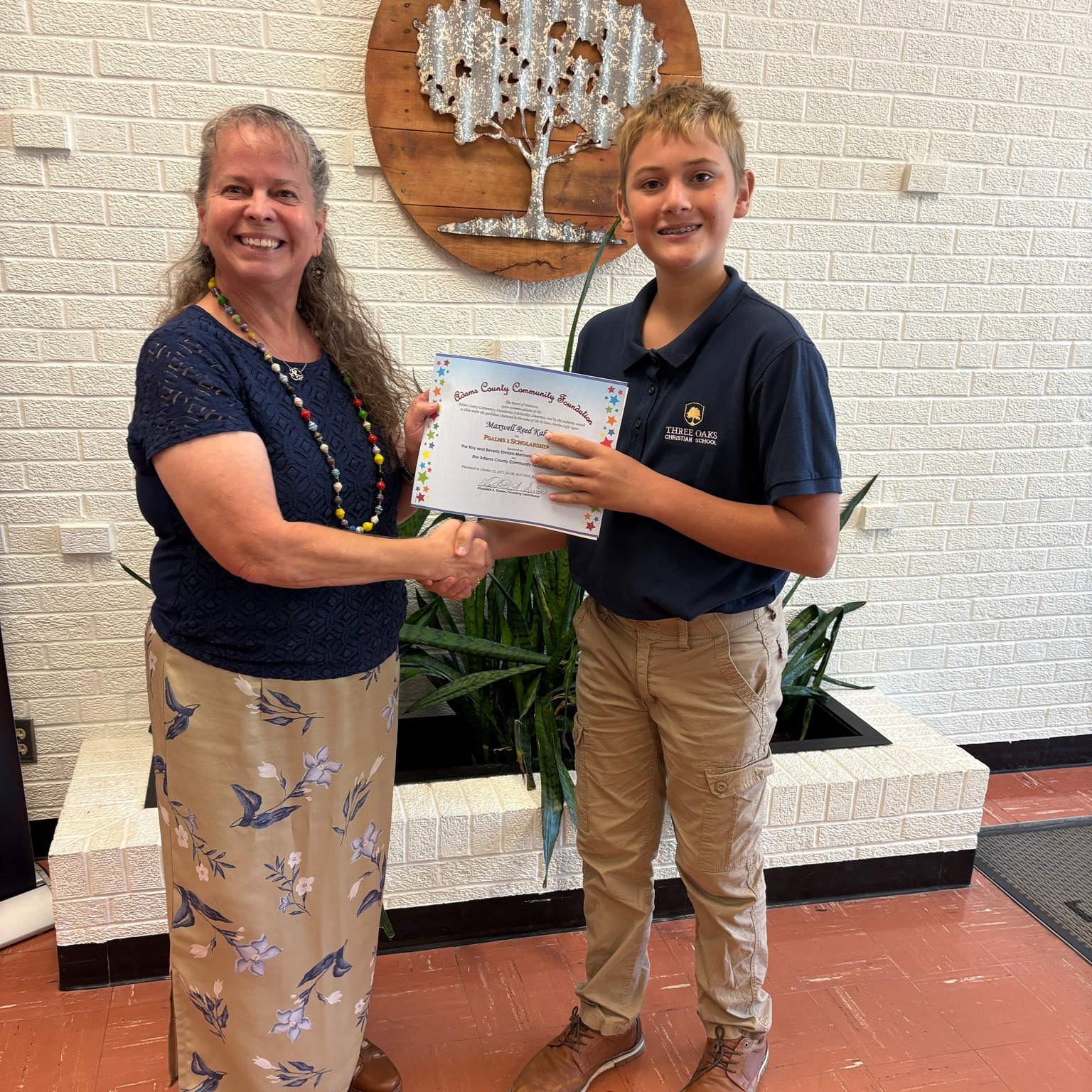 Elizabeth Sisson, Roy and Beverly Ehrsam's daughter and fund representative, is shown presenting a 2025-2026 Psalms 1 / Ehrsam Scholarship to seventh graders, Ezra Henry and Maxwell Kahn.
Elizabeth reports that she wanted to honor the memory of her parents, Roy and Beverly Ehrsam who left a legacy of putting God first. As faithful Christians, Roy and Beverly regularly attended First United Methodist Church in Decatur where they served in many leadership roles. They read God's word daily and provided financial support to many Christian organizations for the purpose of making Christ known to the world.
Elizabeth's desire is that Psalms 1 message will serve as a personal goal of each student who receives this scholarship.
Psalms 1
"Blessed is the man that walks not in the counsel of the ungodly, nor stands in the way of sinners, nor sits in the seat of the scornful, but his delight is in the law of the Lord, and in his law he meditates day and night. He shall be like a tree planted by the rivers of water that bring fruit in season; he leaf also shall not wither, and whatsoever he does shall prosper. The ungodly are not so but are like the chaff which the winds drive away. Therefore the ungodly shall not stand in the judgement, nor sinners in the congregation of the righteous for the Lord knows the way of the righteous, but the way of the ungodly shall perish."
Elizabeth endowed this fund in the ACCF so this annual tribute to her parents will be a perpetual gift to this community.