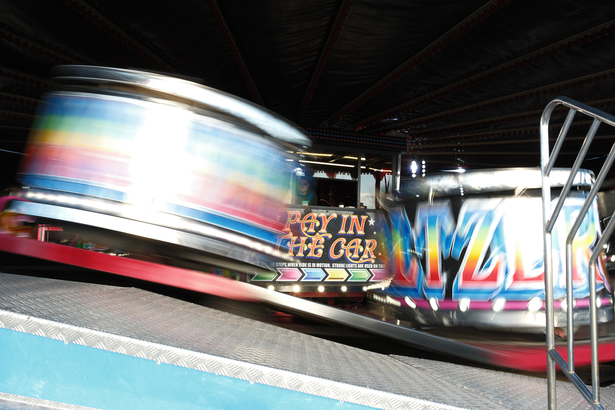 Weekly Prime – Week 10 | 23mm Prime
Lens: Fujifilm XF 23mm f/2.8 R WR
Camera: Fujifilm X-E5
Settings: f/7.1 | 1/15 sec | ISO 64 | 23 mm (35 mm equivalent)
This week’s photo came from the waltzer at Halloween Farm. I slowed the shutter to 1/15 sec to let the movement flow across the frame, with the cars turning into soft streaks of colour while the centre of the ride stayed steady enough to anchor everything.
It is straight out of the X-E5 on Reala Ace with no edits. The film sim handled the bright lights well and kept the colours natural. I stood just off to the side of the platform and waited for the cars to swing through the corner so the motion would cut across the lens in a clean sweep.
#ImACameraGuyNow #OneMistakeAtATime #WeeklyPrime #FujifilmXE5 #FujifilmXSeries #XF23mm #FairgroundPhotography #MotionBlur #LeicestershirePhotography #ChaplainAndCo