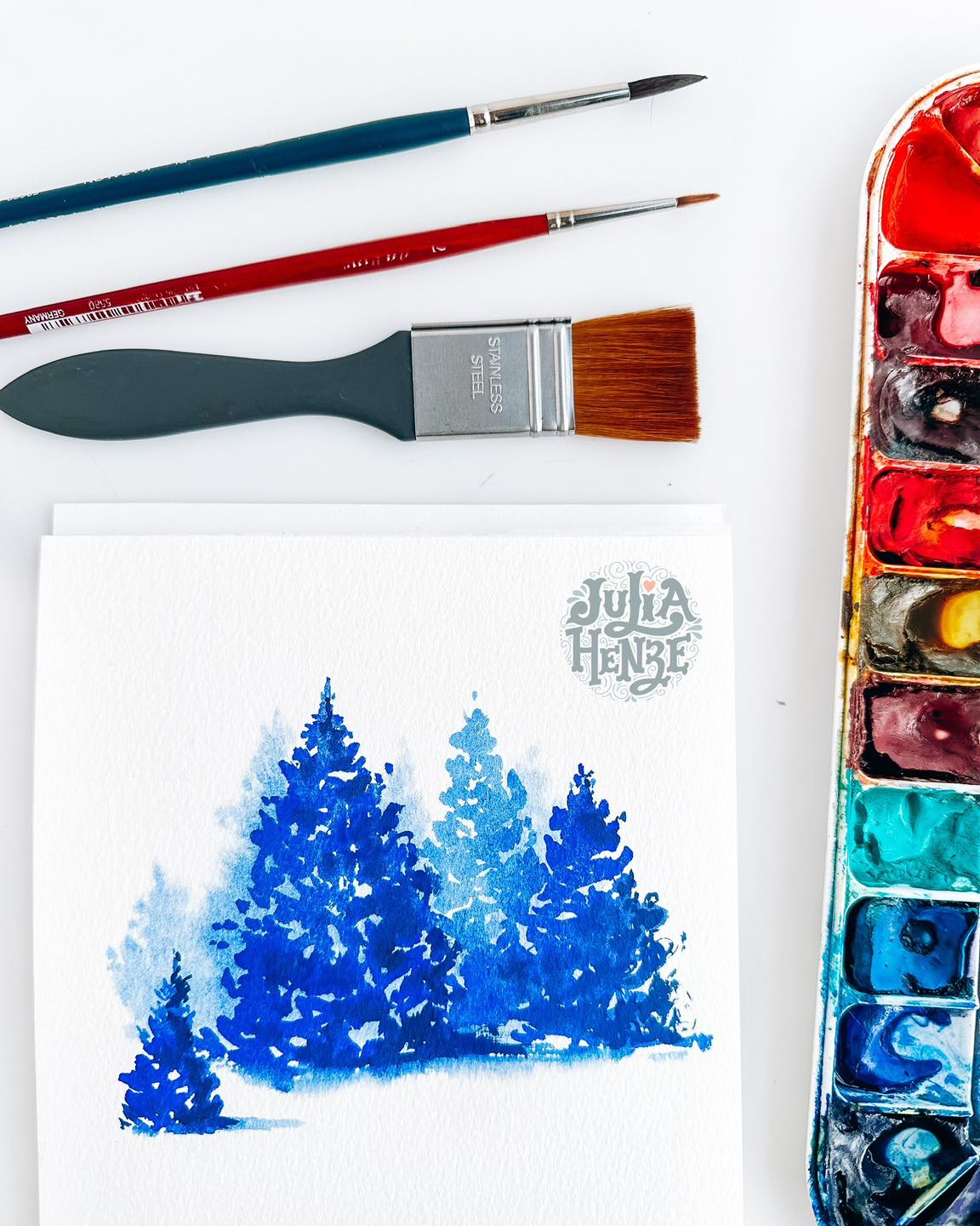 There’s something quietly magical about watery paint. When the color turns transparent and it feels as if light is shining straight through it, gently leading your eyes across the page. Watercolor does this so beautifully. And gouache can too… if you treat it kindly and add enough water🥰
In this sketch, I played with that balance. Soft, transparent layers first. Then a few stronger, opaque touches for depth and shadow. Simple trees, simple shapes, but suddenly the scene feels deeper, calmer and livelier at the same time. It’s almost like glass being touched, with a soft, delicate ring.
It’s a wonderful exercise to practice layering and contrast without overthinking things. Just dab, lift, and trust the process. And yes, it works with watercolor too😉🎨
This is the Beginner Adventure of the week inside Brave Brushes. Want to try it? 🔗 Link in bio.
My friends, have you ever tried creating depth with just one main color?💙🩵
#christmastreepainting #watercolorforbeginners #beginnerartpractice #learningtowatercolor #learntopaint #watercolorpractice #howtopaint #gouacheforbeginners #easywatercolor #artpracticeideas #sketchingforbeginners #layeringpractice #buildingdepth #simplepaintingexercise #gouacheillustration #creativeconfidence #artlearningjourney #juliahenze #bravebrushes #sketchingclub #christmascard