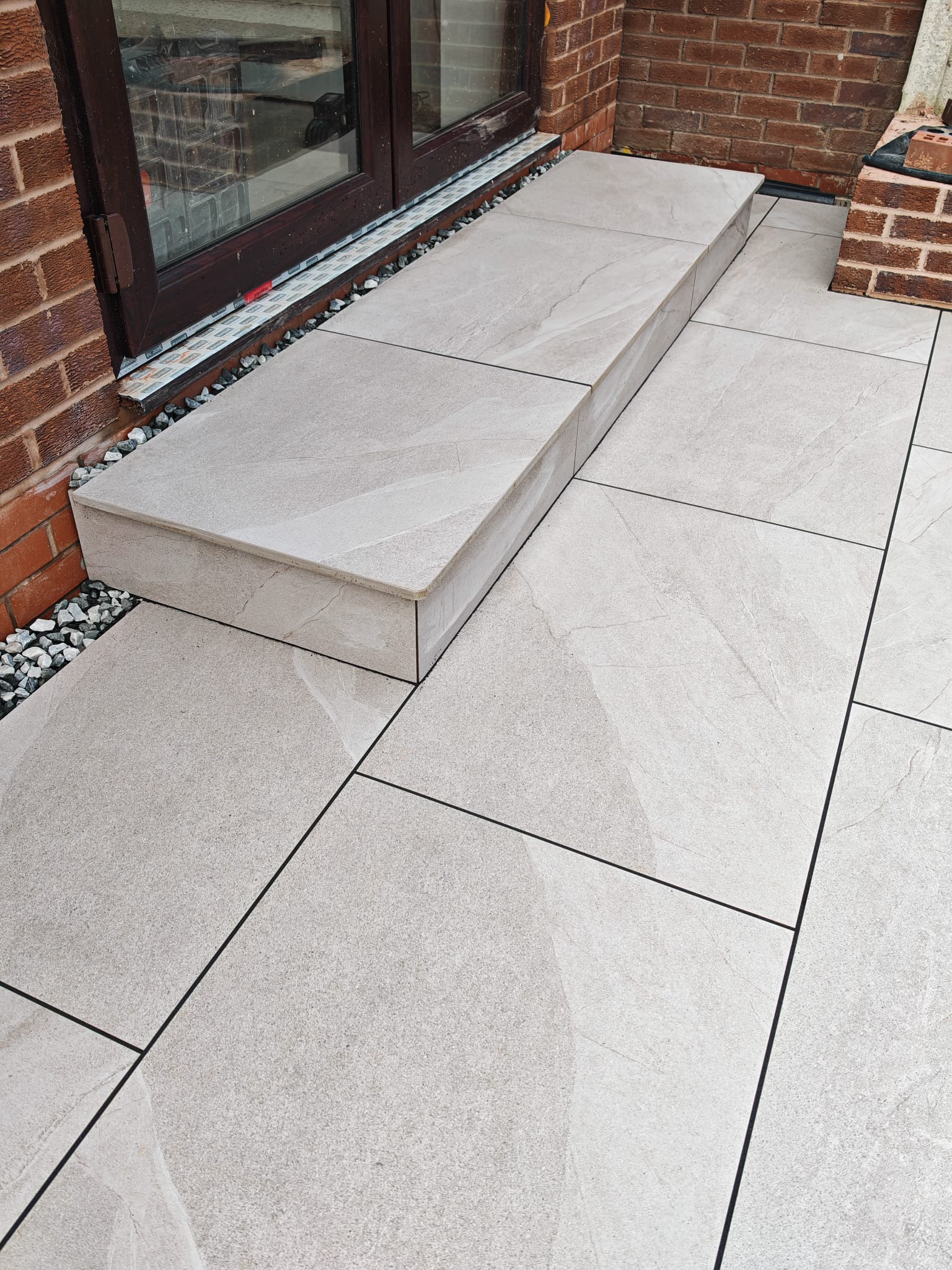 Outdoor Patio Tiling with polished corners step for a rear garden. We are experts in the field so get in touch to discuss your tiling needs