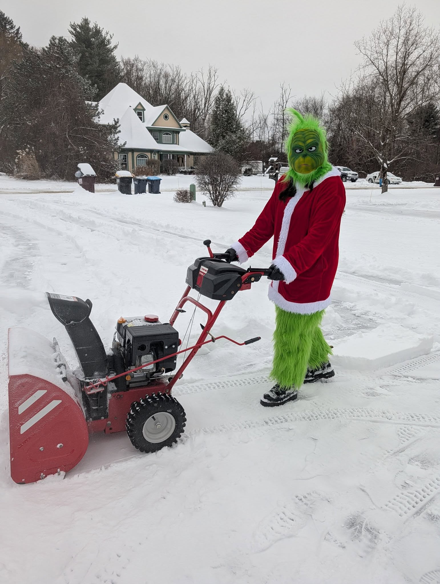 Mr Grinch is snowblowing for us. He's not such a grinch
