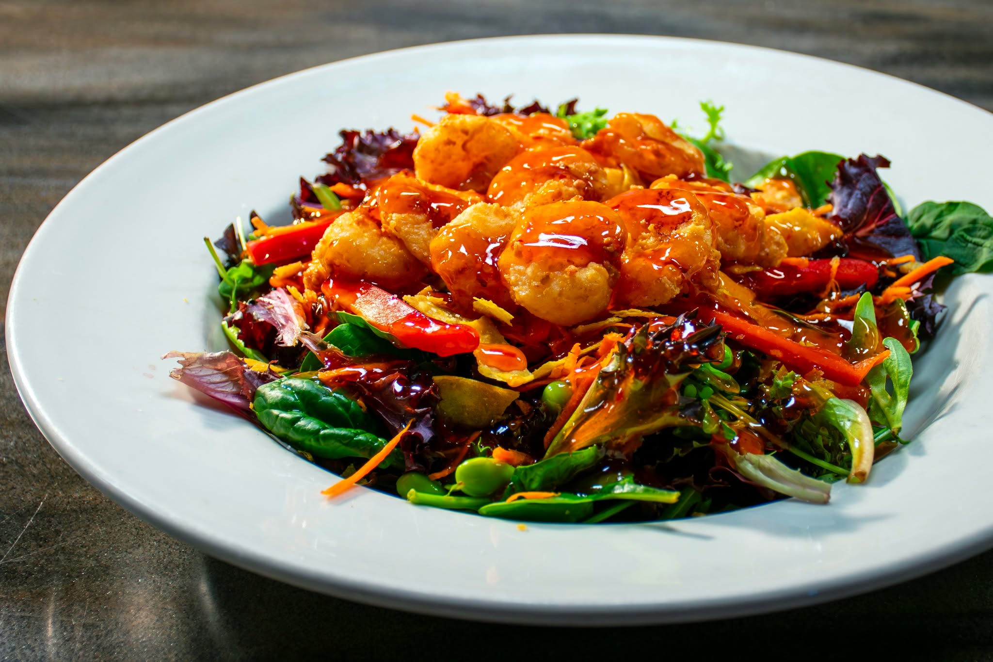 Light bowl, big flavor 😎😋 Helping you eat light + right this year with our Bam Bam Shrimp Salad featuring our signature Bam Bam Shrimp served on an Asian-inspired salad of fresh greens, edamame, shredded carrots + red peppers, accompanied by scratch-made buttermilk ranch dressing! 🥗