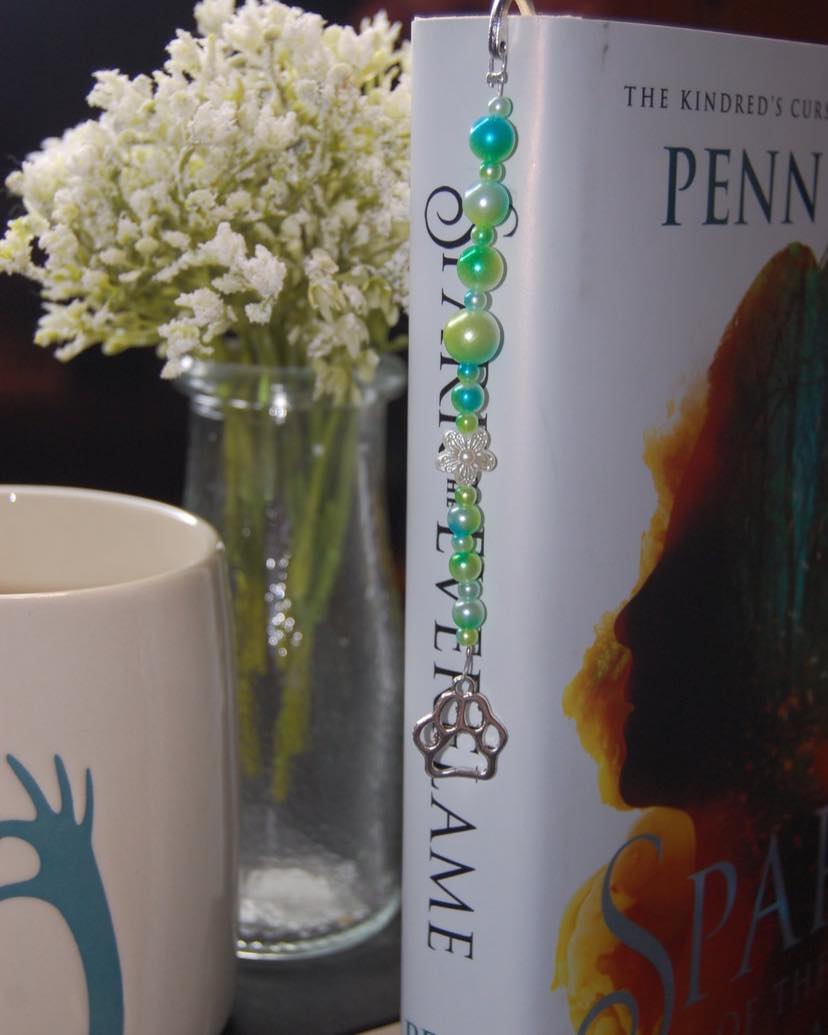 These bookmarks are so fun and hang on the outside of your book so you can enjoy them all day everyday! Colors and charms vary so check them all out at EncyDesigns.com or click the link
https://www.encydesigns.com/product-page/silver-paw-print-pet-charm-bookmark