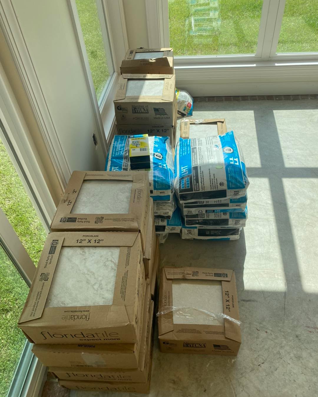 🌞This sunroom already had great bones-natural light, brick accent wall, and a view worth framing. What it needed was a floor to match. I installed this clean, durable tile to bring it all together. Now the sunlight plays across the surface, casting crisp shadows and adding depth to the space. One upgrade, big impact.
