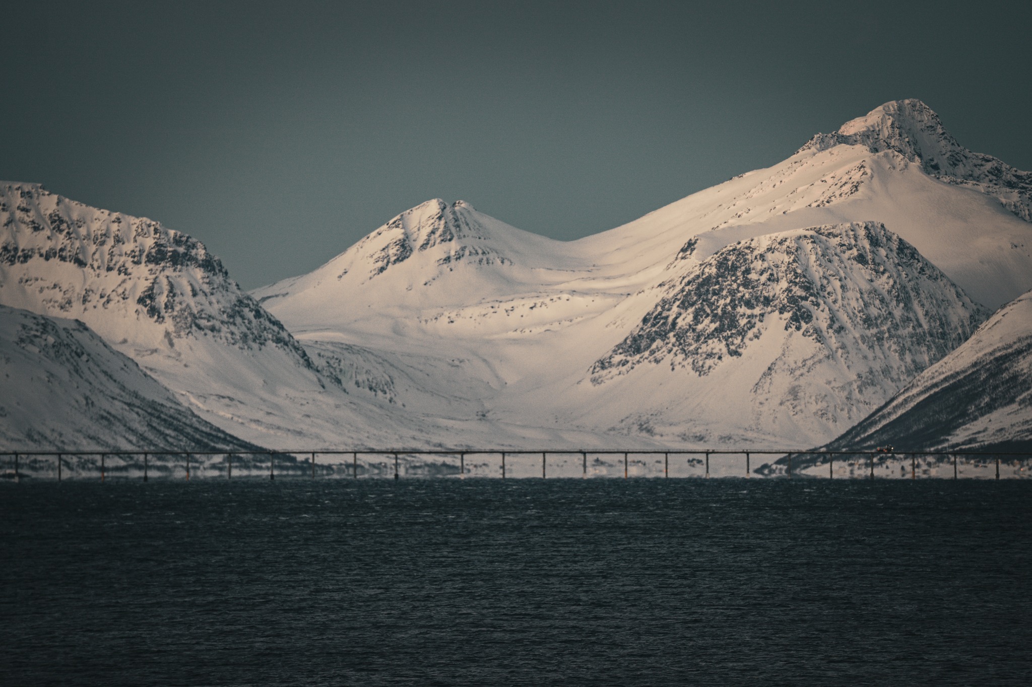 Today was driving along snow-lined roads and stopping when the view opened up. The sea ran alongside the road for long stretches, with mountains rising straight out of it, covered in snow. I shot from low down in places, kneeling in the snow at the edge of the road. Small red huts sat by the water, and bridges cut across the fjord in the distance. There was hardly anyone around. The light changed constantly, shifting from warmer tones earlier on to cold blues and purples as dusk came in. It was quiet, cold, and most of the day was just moving, stopping, shooting, and moving on again.
#ImACameraGuyNow
#OneMistakeAtATime
#NorwayRoadTrip
#ArcticLight
#WinterPhotography
#ColdPlaces
#CoastalNorway
#SnowAndSea
#SlowTravel
#JustOutShooting