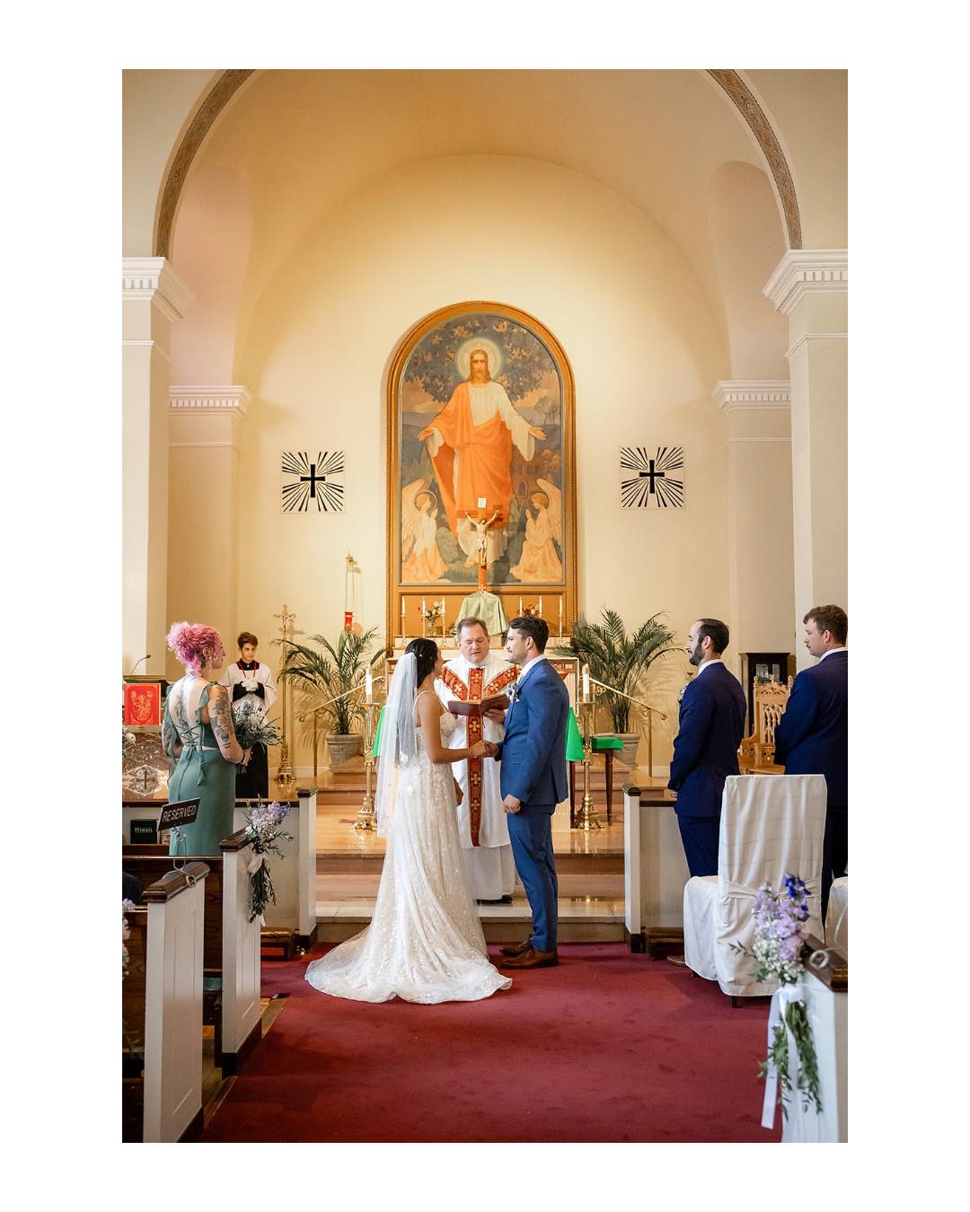Nothing about a Catholic church feels ordinary to me.
They’re so beautiful, and I almost always sneak into the sanctuary before the ceremony to take in the architecture, stained glass, art, and sacred statues.
The reverence in these spaces truly feels holy.