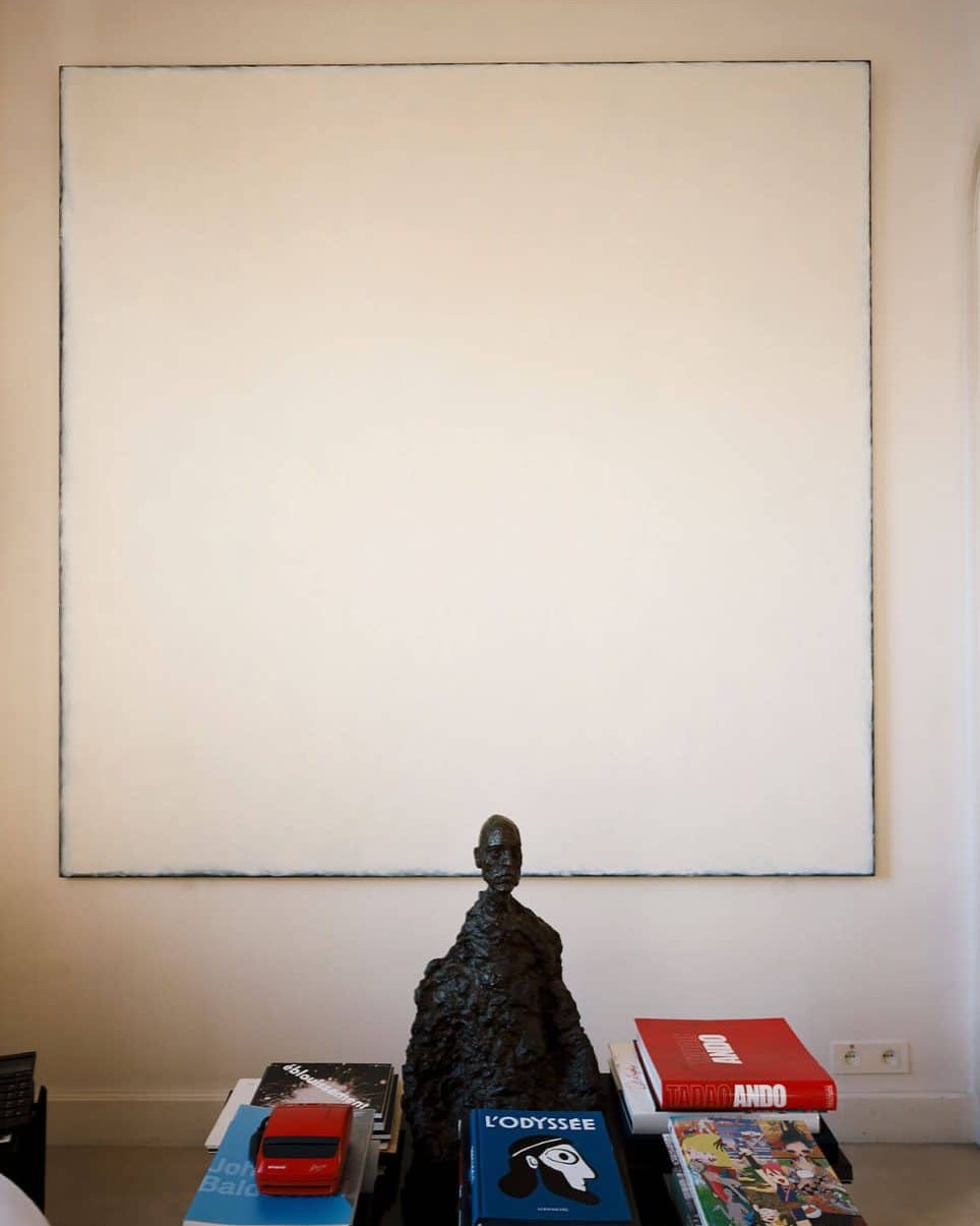 Claude Berri is a French director and producer, also known for his extensive art and design collection. The first work he acquired was a gouache by Magritte, which he paid $50,000 for in the 1970s. He sold it later to buy works by Dubuffet. He recounted seeing his Magritte gouache again at FIAC in the late 2000s, priced at €2,500,000. In the beginning, his collection also included a work by Tamara de Lempicka. Unfortunately, the producer was burgled and the work stolen. He later bought Portrait de Madame Boucart, which he sold after having its cracks restored : the work had become soulless for him. As Claude Berri sold his first company in the mid-1980s, he sought to expand his collection, the central theme of which was emotion and light. He thus became interested in the work of Robert Ryman. After two fraudulent purchases, he bought his first real Ryman at auction for $2,000,000.
In 1990, he opened his own exhibition space, hosting Robert Ryman for its inaugural exhibition. Having formed a strong friendship with the artist since then, he was able to purchase Ryman's works directly from his studio. Claude Berri became one of the artist's greatest collectors in the world, owning seven paintings at the time of his death. Claude Berri truly was one of the greatest French collectors of art and design: his collection included works by Hiroshi Sugimoto, Dan Flavin, Francis Bacon, Francis Picabia, Jean Arp, Pablo Picasso, Alexander Calder, Lucio Fontana, Alberto and Diego Giacometti, Daniel Buren, Jannis Kounellis, Cy Twombly, Yves Klein, Richard Serra, Bruce Nauman, Paul McCarthy, Christian Boltanski, Giorgio Morandi.
Claude Berri died in 2009, leaving behind some 800 works estimated to be worth €65 million. In February 2011, his sons sold part of his art collection (which was initially intended to be going to the Centre Pompidou) to the Emirate of Qatar (nine works sold for a total of €50 million). Another part of his collection was sold by Christie's across five sales. Estimated at €5.5 million, the collection fetched €8.3 million. As for the rest of his collection, it is the subject of a legal battle that is still ongoing.
#claudeberri #artcollection