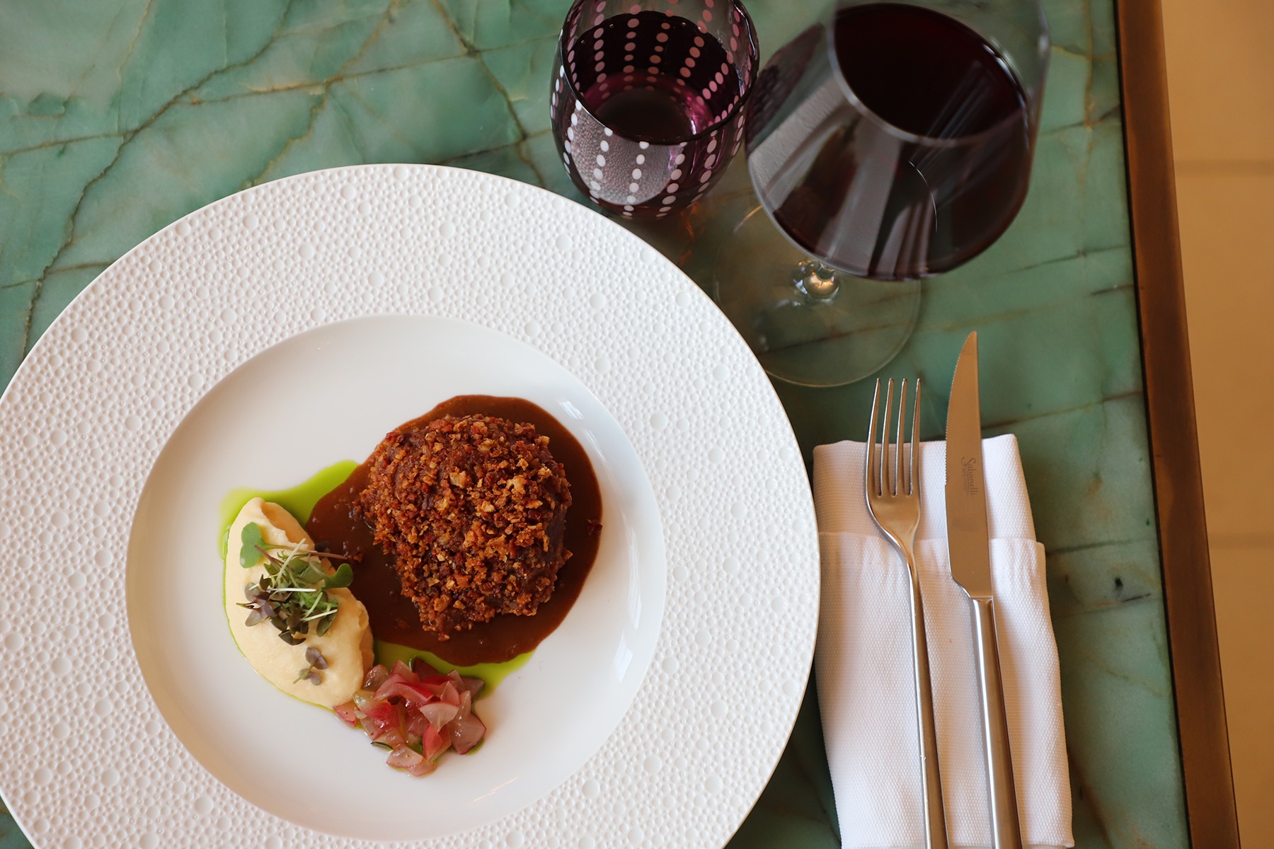 Eighteen hours. That's how long this pork cheek spends cooking before it earns that golden, crispy exterior. Inside, it's yielding and rich; outside, it shatters at the touch of a fork.
The grape and rosemary tartare cuts through with just the right amount of brightness, and the cauliflower purée underneath ties it all together. It's one of those dishes where you understand exactly why patience matters.
Join us for dinner and see for yourself.
#FoodieFinds #restaurantsmalta #PalazzoParisio #PalaceLife #visitpalazzoparisio #visitthepalace #palazzoparisiomalta