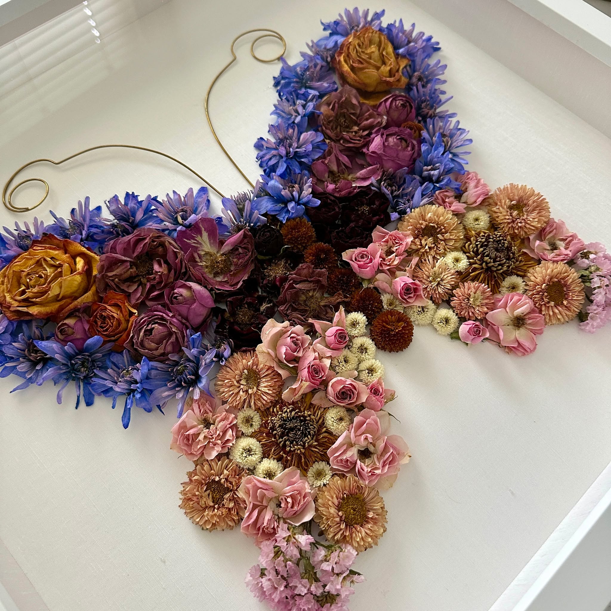 A memorial piece created with love and care 🦋🤍
These flowers were preserved and shaped into a butterfly — a symbol of remembrance, transformation, and the enduring presence of those we hold close.
Swipe to see the journey: from the original arrangement, through to the finished piece, and a closer look at the blue chrysanthemums that form part of this tribute. Each bloom was handled thoughtfully, honouring the meaning they carry
#MemorialFlowers #RemembrancePiece #FloralKeepsake #InLovingMemory #CherishedBlooms