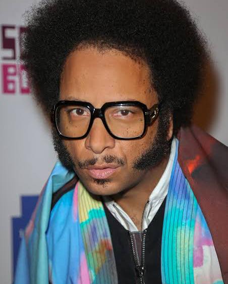 Boots Riley makes films the way a punk band crashes a boardroom meeting: loud with ideas, allergic to politeness, and daring you to keep up. His style fuses absurdist satire with blunt political rage, taking capitalism, race, and labor exploitation and bending them until they squeal in discomfort. In Sorry to Bother You, Riley weaponizes surrealism not as quirky window dressing, but as a delivery system for hard truths, where telemarketers, corporate slogans, and even the laws of reality itself collapse under the weight of unchecked greed. His satire never winks or apologizes; it stares you down, daring you to laugh while realizing the joke is also on you. Riley’s films feel less like passive viewing experiences and more like cinematic protests, using humor, shock, and dream logic to expose how normalized exploitation has become, then leaving the audience to sit with the mess.
#bootsriley #blackcinema #movies #BlackHistoryMonth #blackhistory365