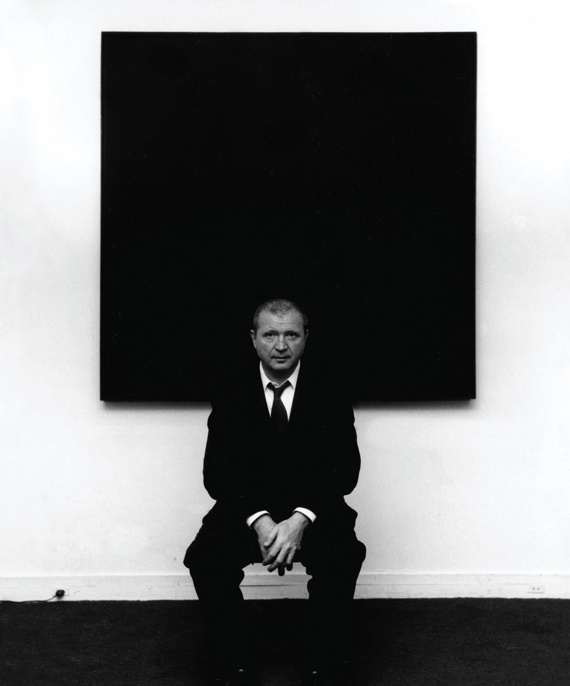 Ad Reinhardt was born in the State of New York in 1913. He was a major influence on conceptual art, minimal art and monochrome painting. He studied art history with Meyer Schapiro, and began painting his first abstract pictures in the second half of the 1930s, influenced by cubism, constructivism and the compositions of Piet Mondrian. He was also a member of the American Abstract Artists (AAA).
He first made a name for himself in the 1940s with paintings that avoided any form of representation: irregular lines, fields of color, etc. By 1950, more uniform color bricks began to emerge. Reinhardt gradually limited his palette to a single color, and produced works that appeared almost monochrome, but in fact featured different shades of the same color (all red, all blue, all white), or closely related hues of the same value. His paintings thus encouraged viewers to actively engage in the act of looking, to explore more subtle chromatic variations, and the perceptual properties of color in what appeared to be a simple neutral plane.
In the 1960s, he became known for his paintings, this time composed of multiple shades of black. He wished to strip art of figuration and expression, of any evidence of the artist's personality, narrative or emotional content, aiming instead for pure abstraction. Using black exclusively, he bypassed the qualities of light and contrast associated with color, going so far as to erase brushstrokes to get rid of the textural qualities attached to paint. These black paintings raises the question of whether something absolute can exist, even in the dark. For Ad Reinhardt: “Art is art. Everything else is everything else.” Between 1953 and his death in 1967, the artist painted only black works—twenty-five in total.
#adreinhardt #contemporyart #monochrome #minimalart #abstractart #conceptualart