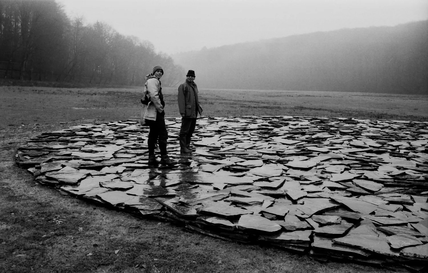 Born in 1939, Konrad Fischer is one of the major figures of the post-war European artistic avant-garde. He played a decisive role in introducing minimalist, conceptual, and Arte Povera art in Europe at a time when these movements were still largely misunderstood.
In October 1967, he and his wife opened an exhibition space in a disused alleyway in the center of DĂŒsseldorf. Their first exhibition focused on Carl Andreâs work, at a time when minimal art was unknown in Europe. This venue quickly became a pioneering platform for a generation of artists who would go on to redefine contemporary art: Sol LeWitt, Dan Flavin, Donald Judd and Bruce Nauman.
The Fischers championed a radical, demanding vision of art, focused on ideas, space, and the relationship with the viewer rather than on the decorative qualities of objects. And they didn't just exhibit works: they also invited artists to come to DĂŒsseldorf. This led to the creation of an international exchange network that encouraged the production of site-specific works: sculptures, paintings, and installations designed for the gallery space. Daniel Buren created his first spatial interventions, Gilbert & George presented their Singing Sculpture.
Many major artists presented their first European solo exhibitions there, including Richard Long, On Kawara, Lawrence Weiner, and Robert Ryman. Establishing DĂŒsseldorf as a major center for contemporary art, the gallery also supported new conceptual directions in painting and photography with artists such as Robert Mangold, Alan Charlton, Bernd and Hilla Becher. And, shortly after the term Arte Povera was coined, Konrad Fischer introduced its major figures âGiuseppe Penone and Jannis Kounellis.
After Konrad Fischer's death in 1996, the gallery continued its activities and expanded its program to include new generations of artists: Tony Cragg, Thomas SchĂŒtte. In 2007, a second space opened in Berlin. Today, the gallery continues to bring together five decades of art history with young contemporary creation, while remaining faithful to its founding commitment to minimal, conceptual, and experimental art.
#konradfischer #conceptualart #minimalart