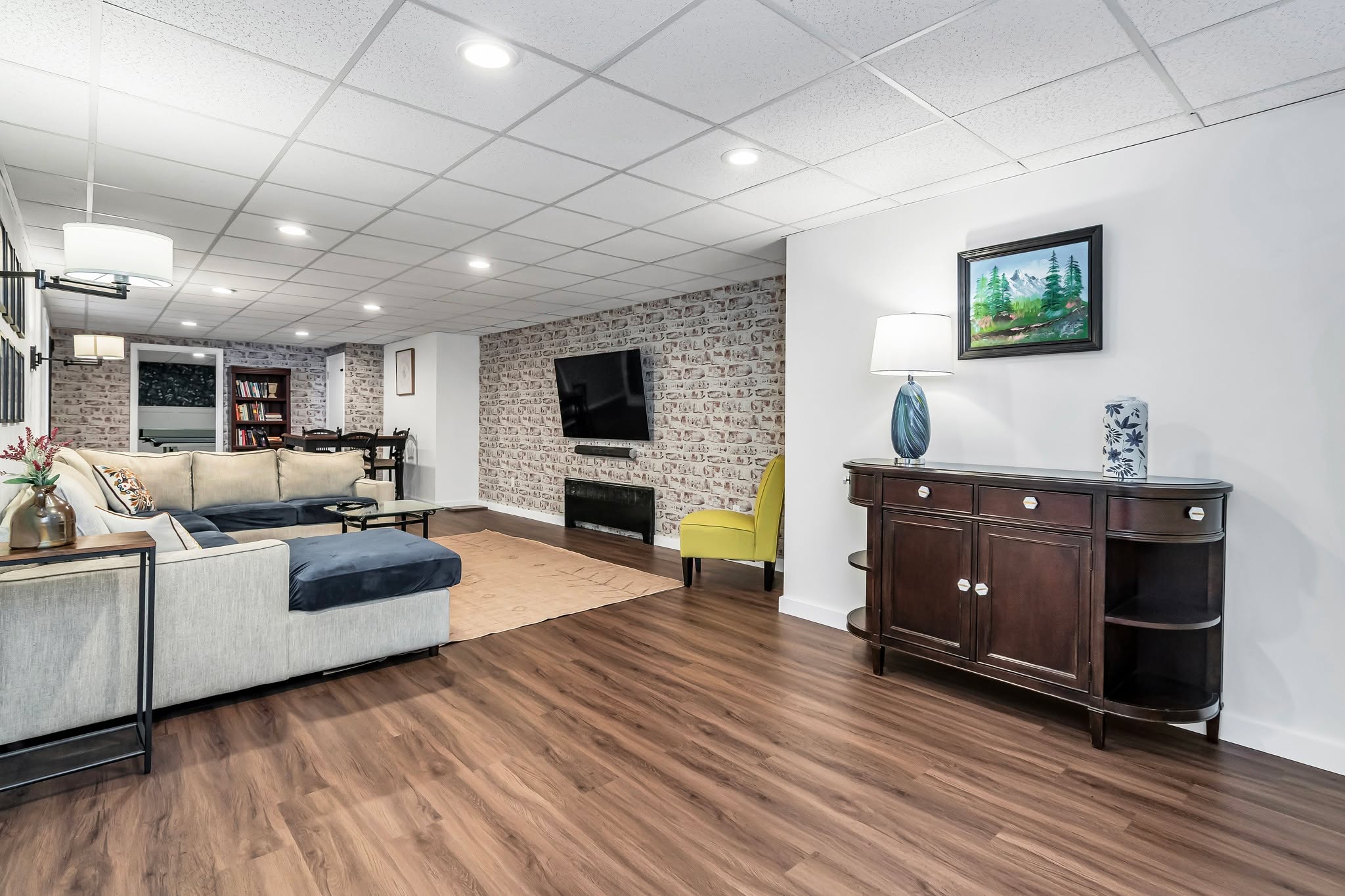 An entertainment space that feels organized, calm, and luxurious 🌿 The bold fireplace feature wall, textured brick, and warm flooring create a balanced setting for gathering, relaxing, and hosting.