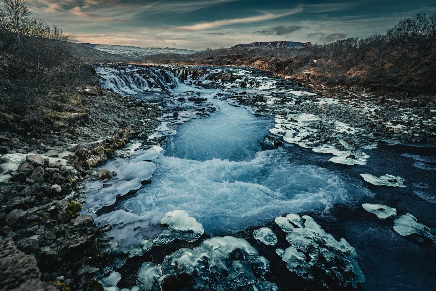 Weekly Prime – Week 21 | 20mm
Lens: Sony FE 20mm F1.8 G
Camera: Sony A7 III
Settings: ISO 200 | 1/640s | f/4.0
This weekly prime is from last week’s Iceland trip. Obviously Iceland is full of amazing compositions so it’s almost tricky to get one wrong!
With the width of the 20mm it gets everything, so positioning is important. In this case a little hop over a bit of rope closing a walkway that led to a small ledge under the tourist bridge provided that perfect position.
There was a lot going on here in a good way. Ice-crusted rocks framing both sides, that ridiculous blue water cutting back through the middle, the falls in the background, hills beyond. The wide angle just pulls it all together nicely.
Shot at f/4.0 to keep sharpness across the whole frame without going so tight that the sky lost any character. 1/640s was fast enough to hold some texture in the moving water rather than smoothing it all out. ISO 200, good light, no excuses on that front at least.
Great location, genuinely wild conditions, and very average photography. One mistake at a time.
#ImACameraGuyNow
#WeeklyPrime
#OneMistakeAtATime
#ShotOnSony
#SonyA7III
#20mmPrime
#WideAnglePhotography
#Iceland
#Bruarfoss
#LandscapePhotography
#LearningPhotography